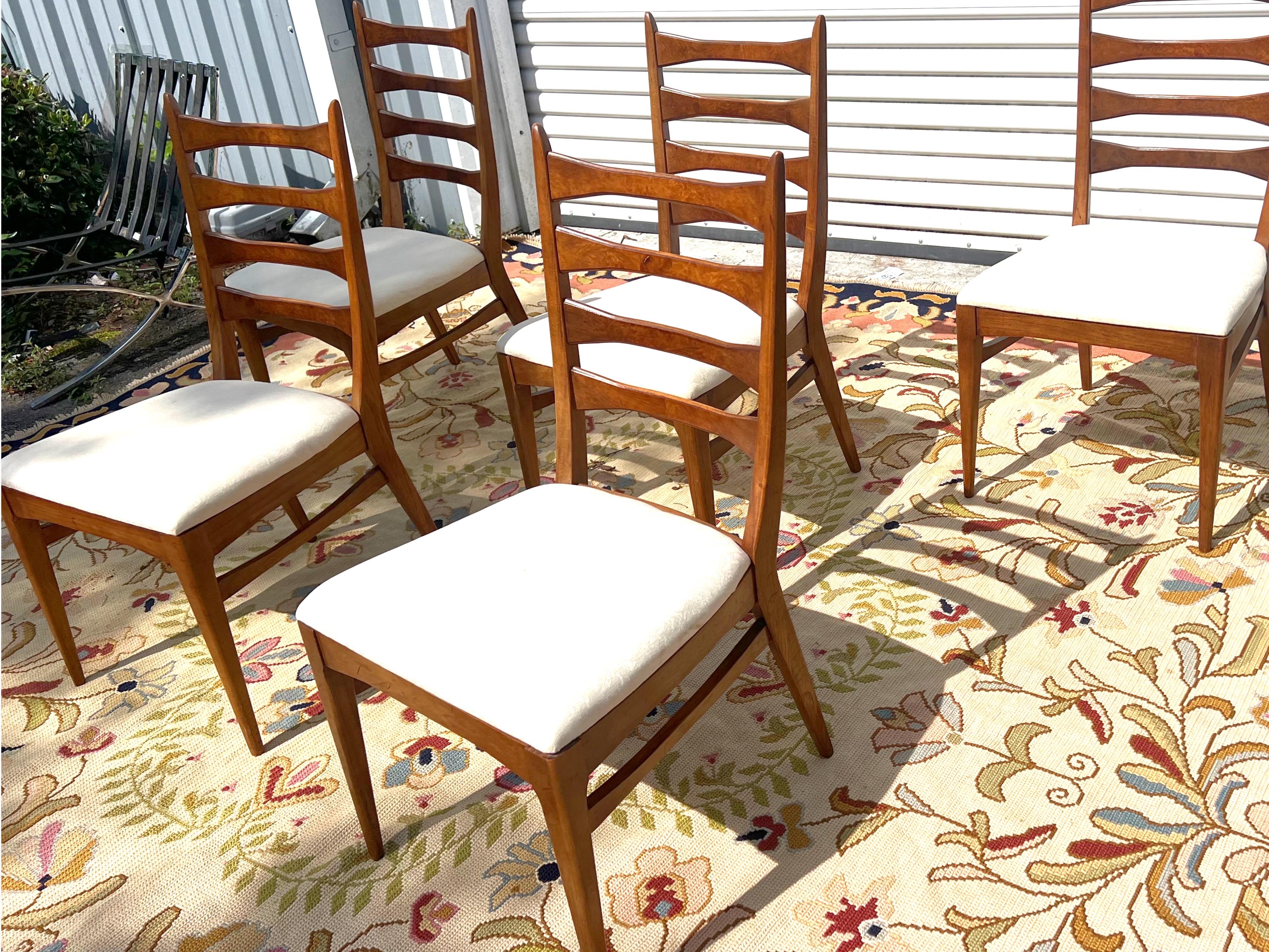 Mid-Century Modern burrled back cat eye/ladder back dining chairs Chairs in the style of kent Coffey/Brown Saltman. These chairs are unique with the burl finish on the backs as well as the swooping stretcher that connects the front chair legs to the
