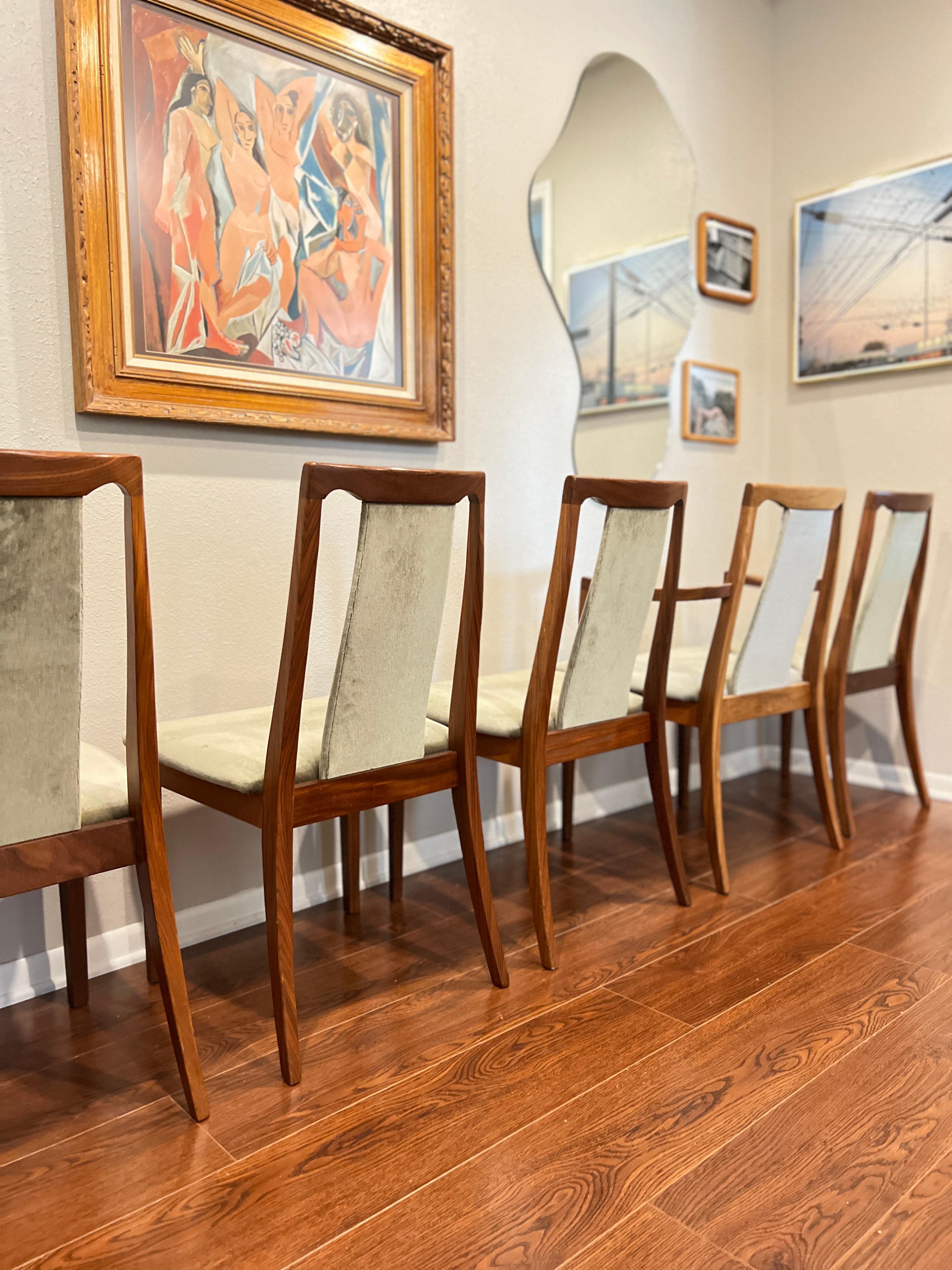 A set of 6 mid century modern style dining chairs by G plan, circa 1980s. Includes 2 captains chairs and 4 armless chairs. The green velvet is original and in surprisingly good condition. Tags still intact on the bottom. Chairs are structurally