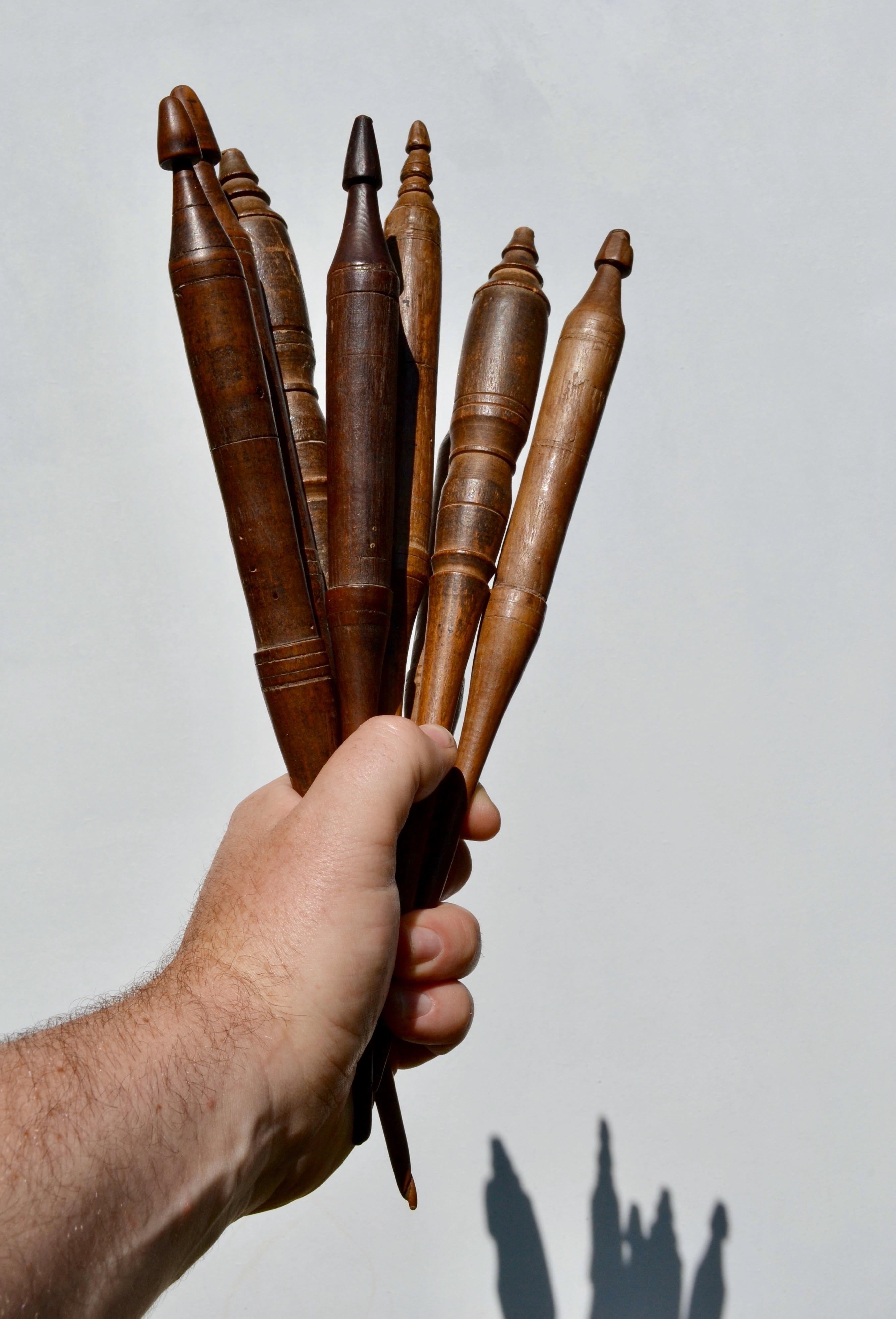 

A rare and decorative set of eight hand-turned wooden distaffs (quenouilles), likely dating to the 19th century, France. Each piece displays unique lathe-turned details, bearing the patina and character of time. Traditionally used in spinning,