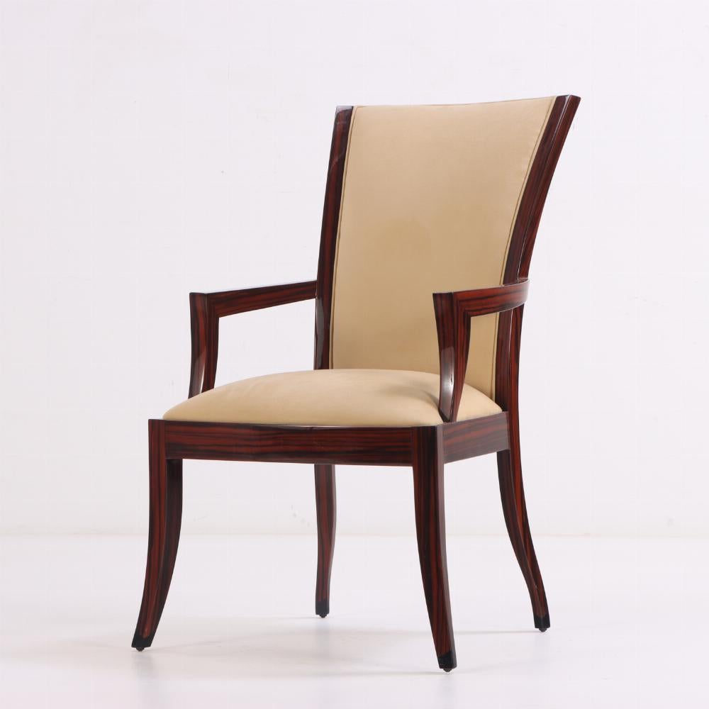 This fabulous set of dining or bridge chairs is clearly inspired by seating of the Art Deco period, particularly similar chairs by Jean-Michel Frank and James Leleu. A glamorous look, they have dramatically curved backrests, angular arms and four