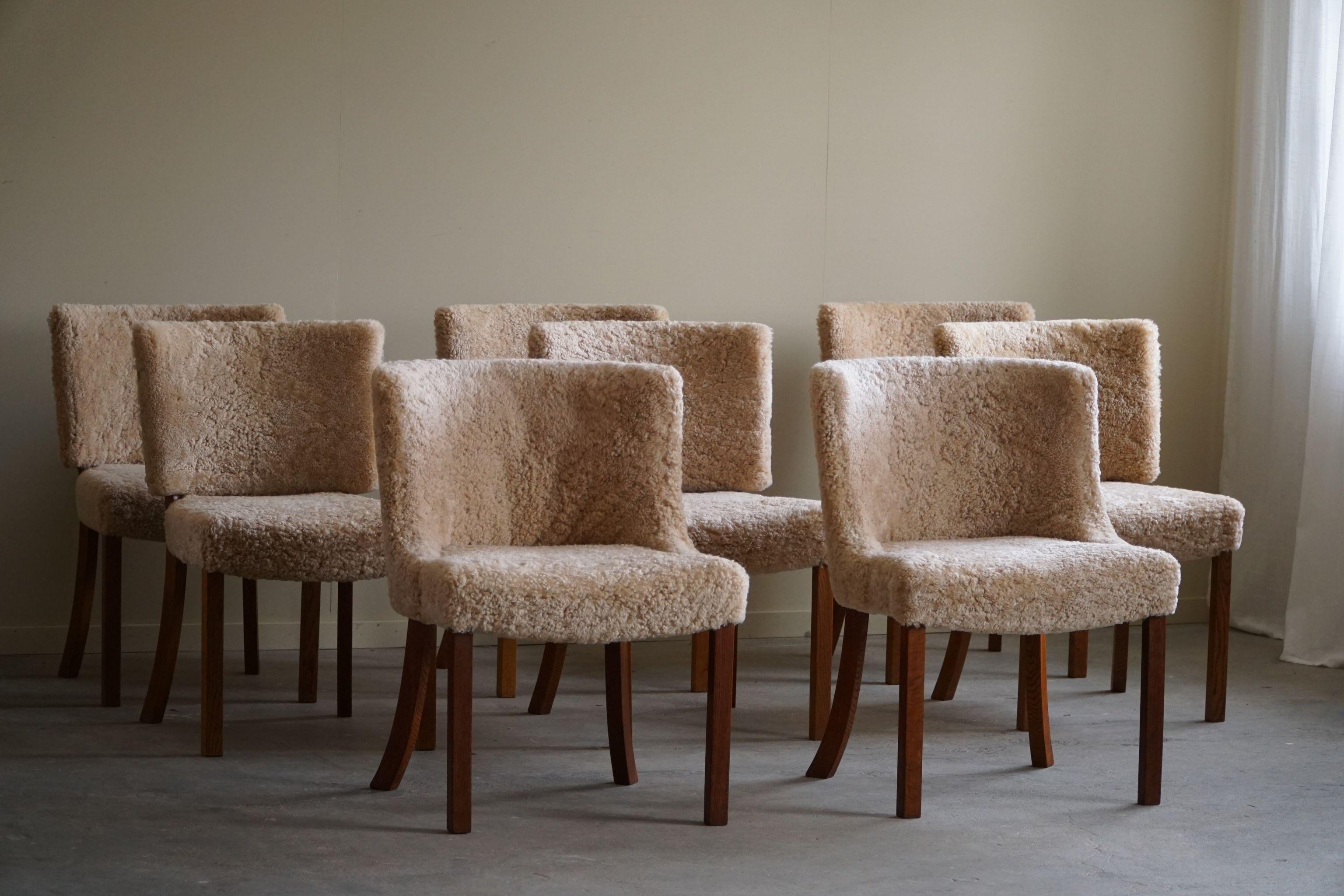 A rare set of 8 classic dining chairs, attributed to Kaj Gottlob for Fritz Hansen. Made in the 1940 - 1950s. Newly reupholstered in a great quality shearling lambswool, elegant shaped legs made in solid oak. The general impression is really good.