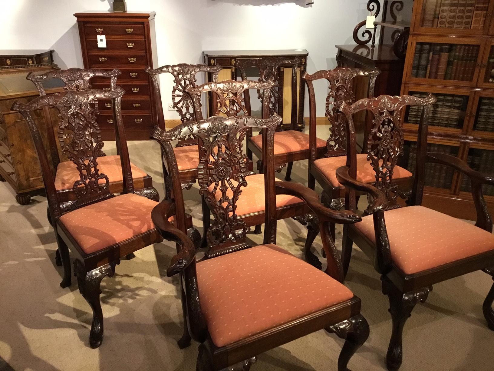 A fine quality set of 8 mahogany Chippendale Revival dining chairs including two carver armchairs. Each chair having a Fine acanthus carved top rail with extremely delicately pierced ribbon back splats which feature carved thistle detail. The