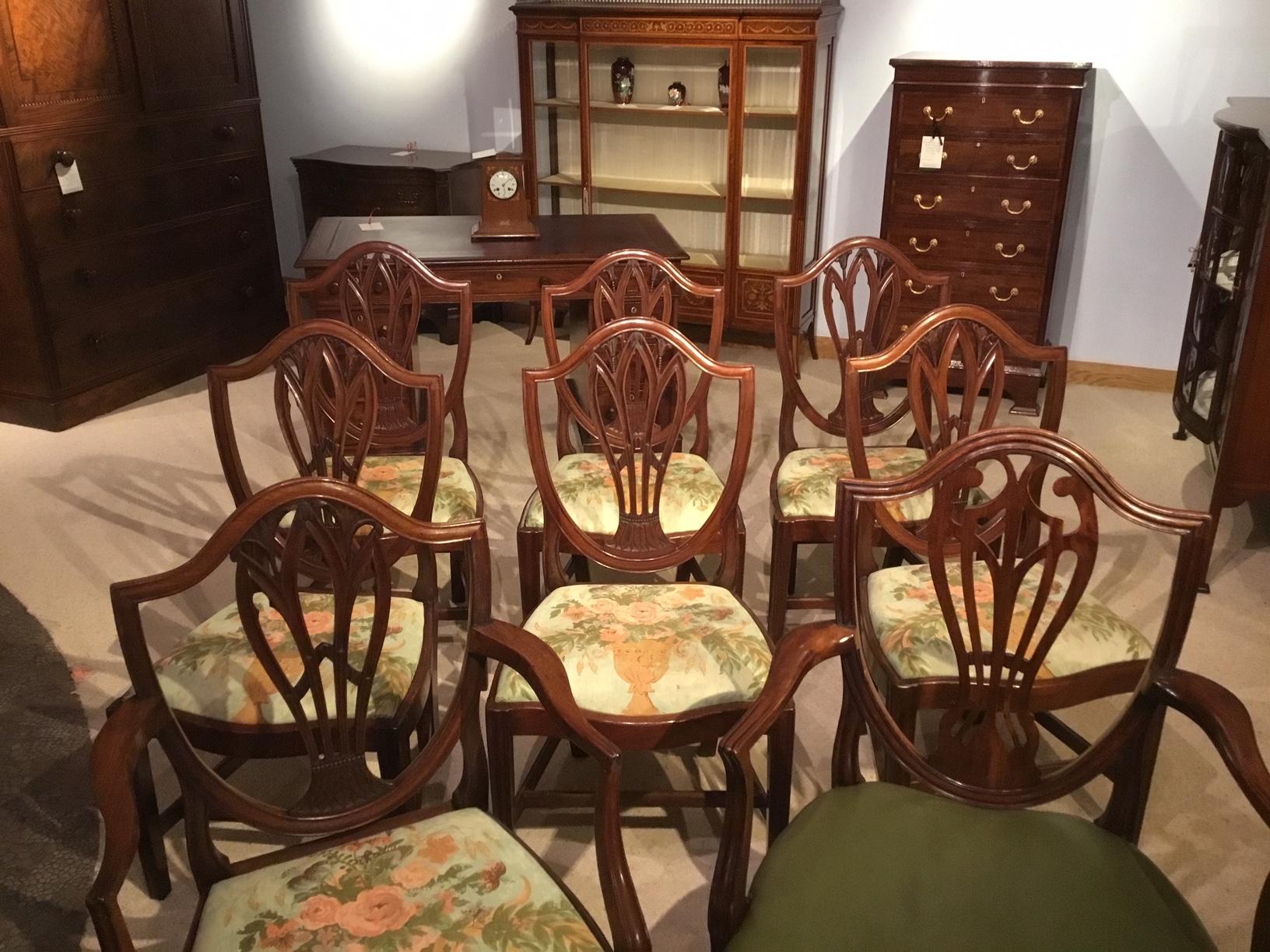A good set of 8 (7+1) mahogany Georgian antique dining chairs. Seven chairs are matching and there is one of the same Period but a slightly different design. The seven chairs ( 6 stand chairs and 1 armchair) each having shield shaped backs with a