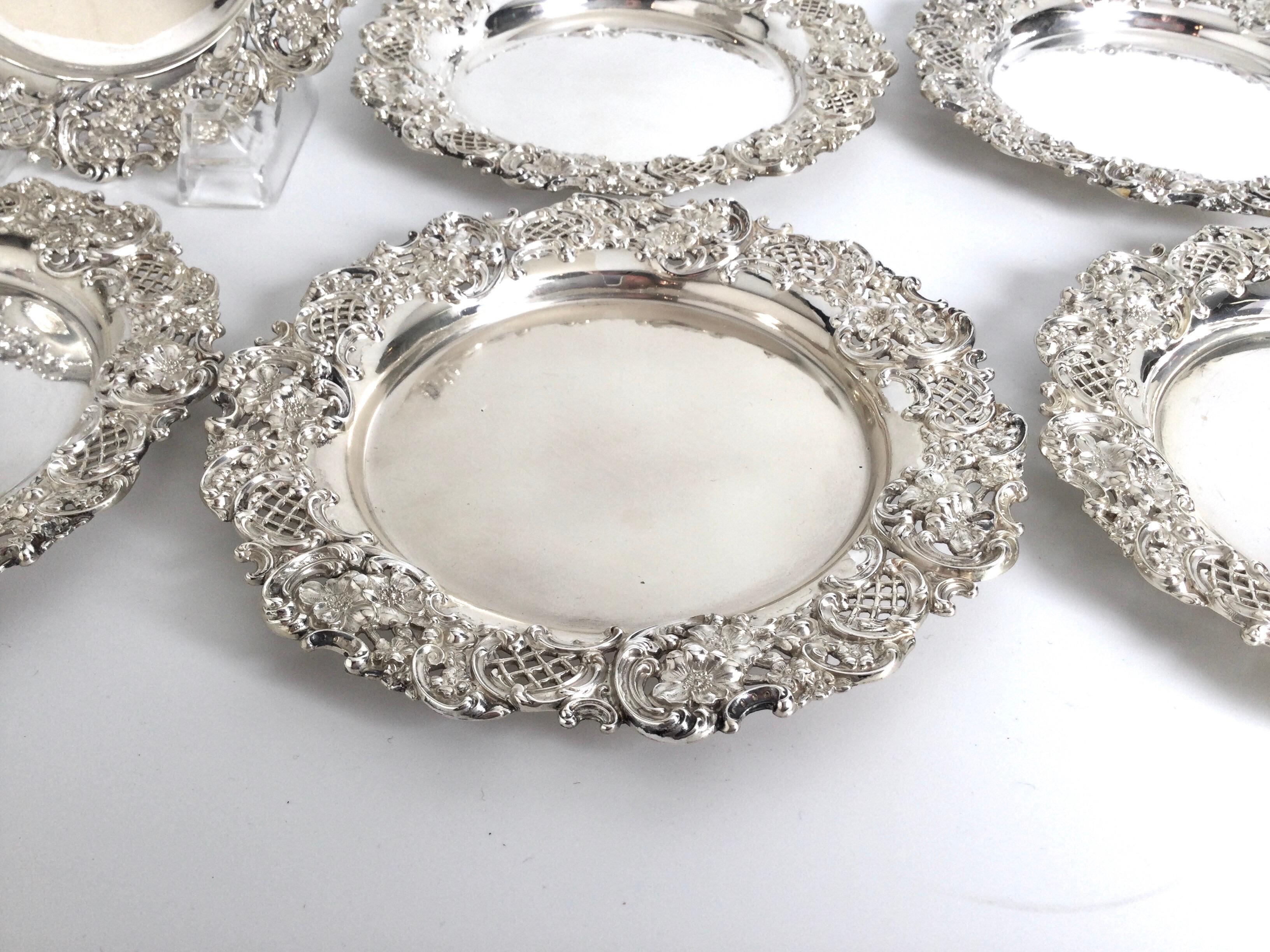 A set of 8 sterling silver reticulated 6.5 inch bread plates. The elaborate pierced borders retailed by J. E. Caldwell and attributed to Gorham. Good weight not stamped but cast.