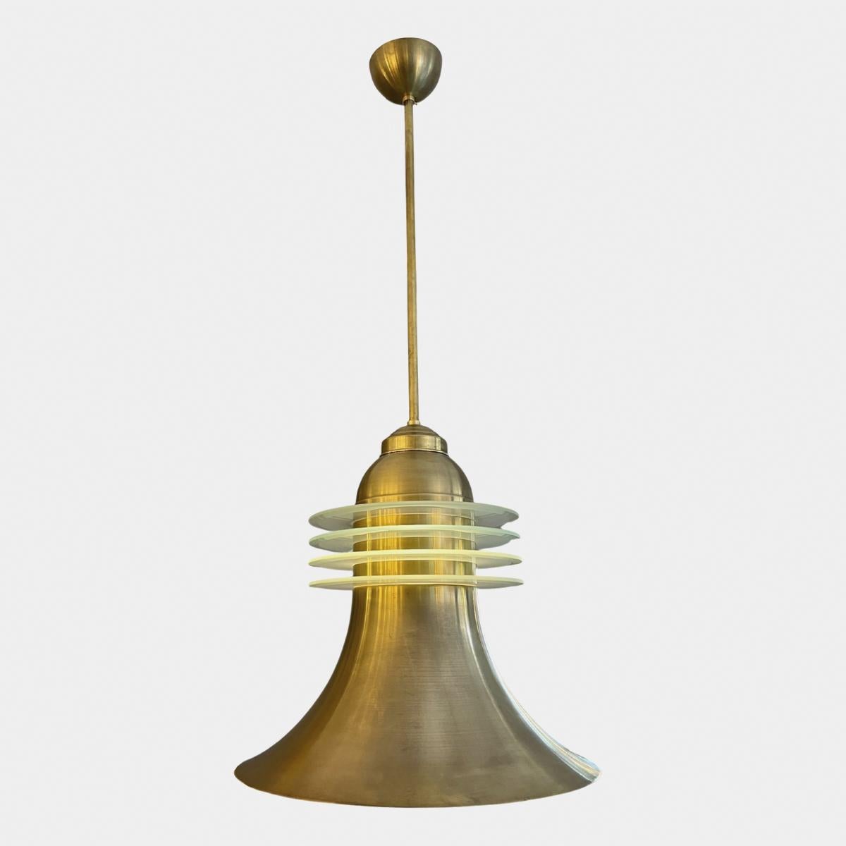 A set of 8 brass and frosted glass pendants from the late Art Deco to midcentury period. The brass bell shaped light with four rings of frosted glass as a central diffuser, also lit from inside. 4 pairs available can be sold as pairs or single lamps