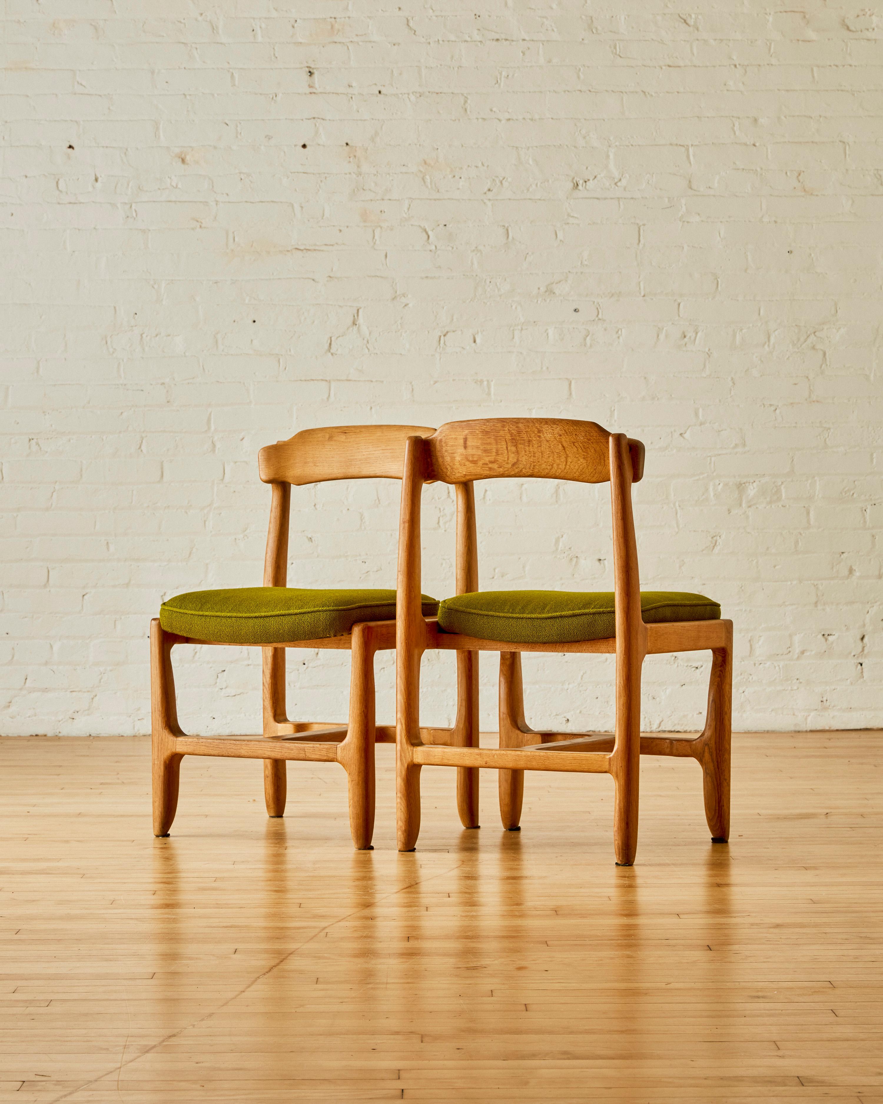 Wool A set of 8 oak Guillerme & Chambron dining chairs