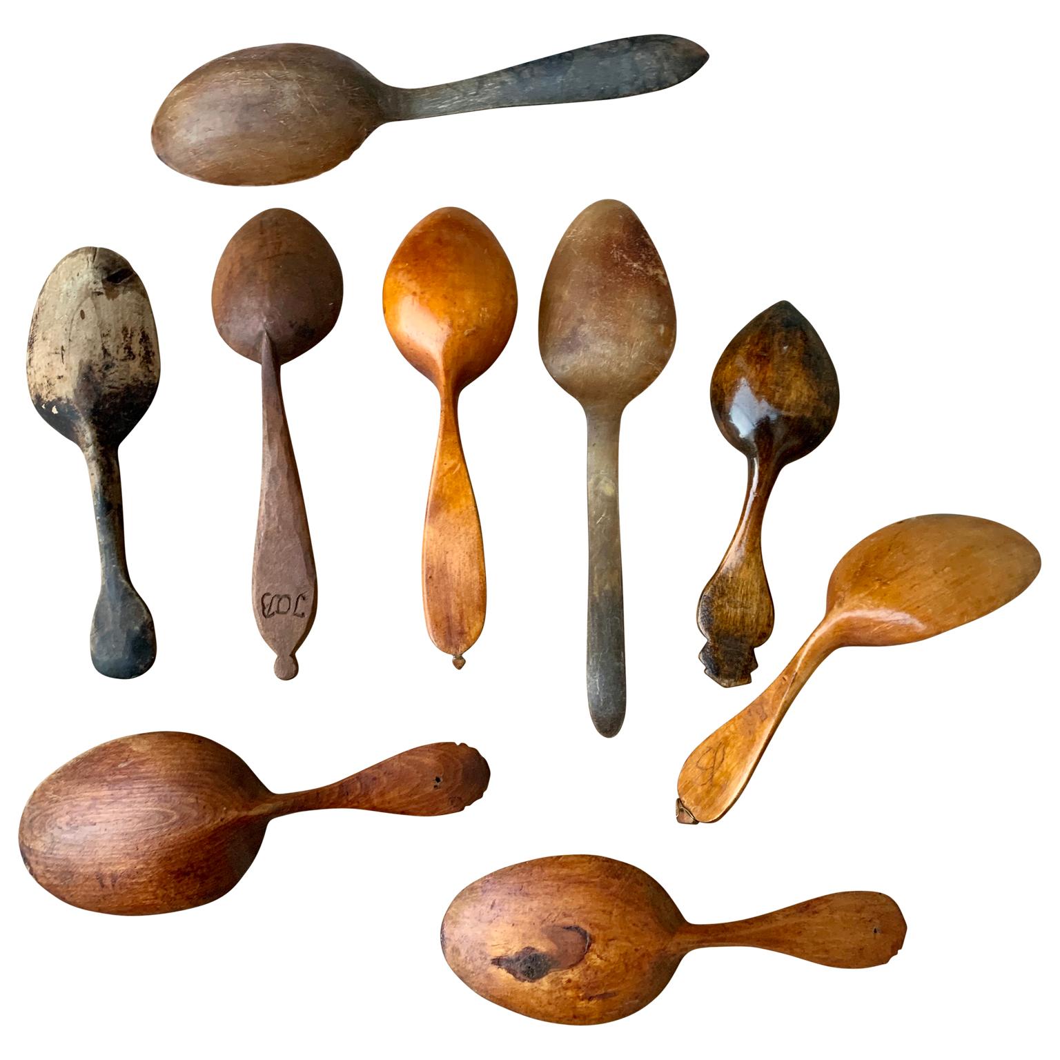 A set of 9 Swedish hand carved spoons from 19th century. In both cow horn and wood, some painted and dated.