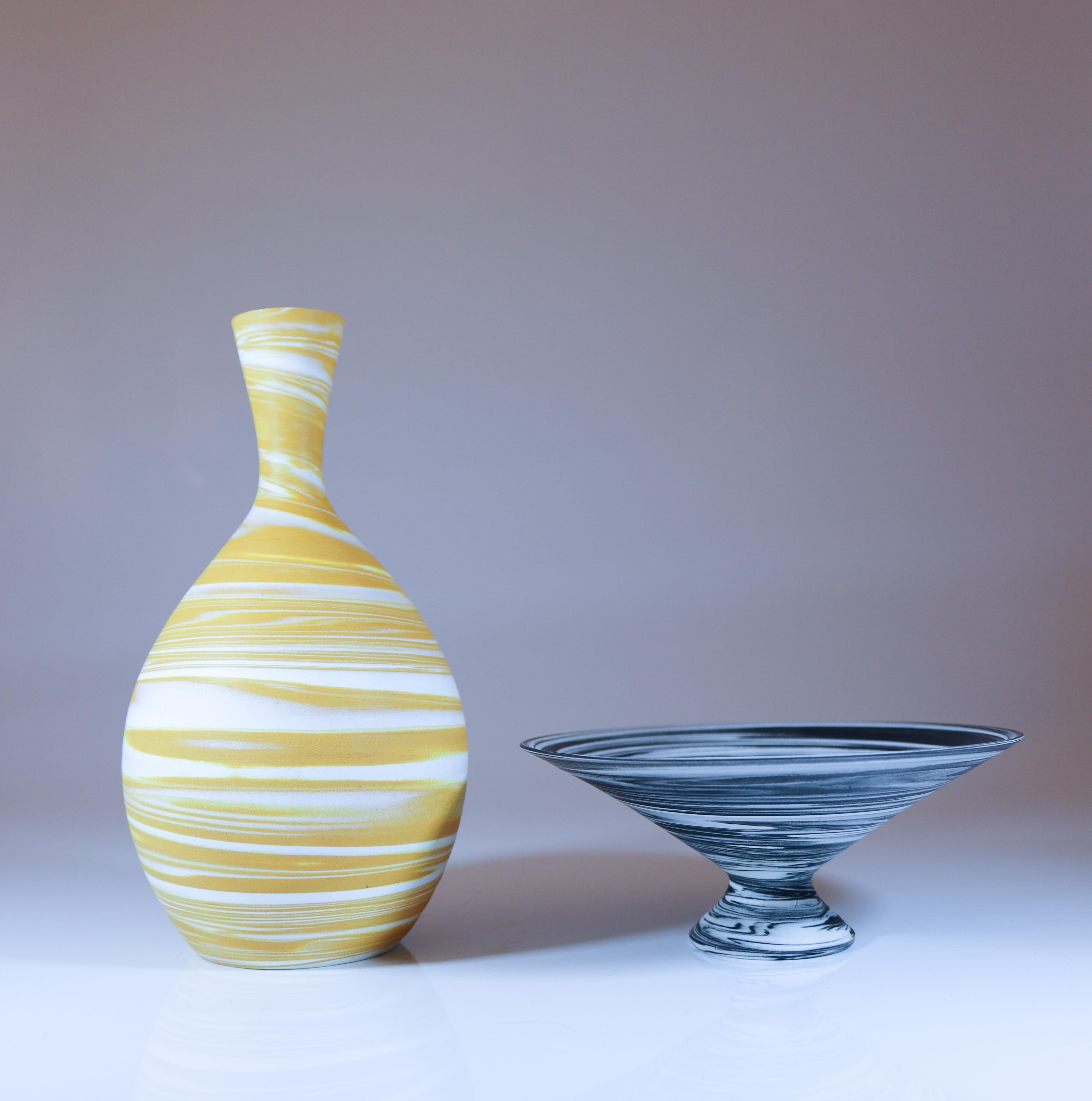 A bowl and a vase with the same swirl glaze designed by Sven Wejsfelt in the beginning of the 1980s at Gustavsberg in Sweden. The bowl is 11.5 cm (4.6