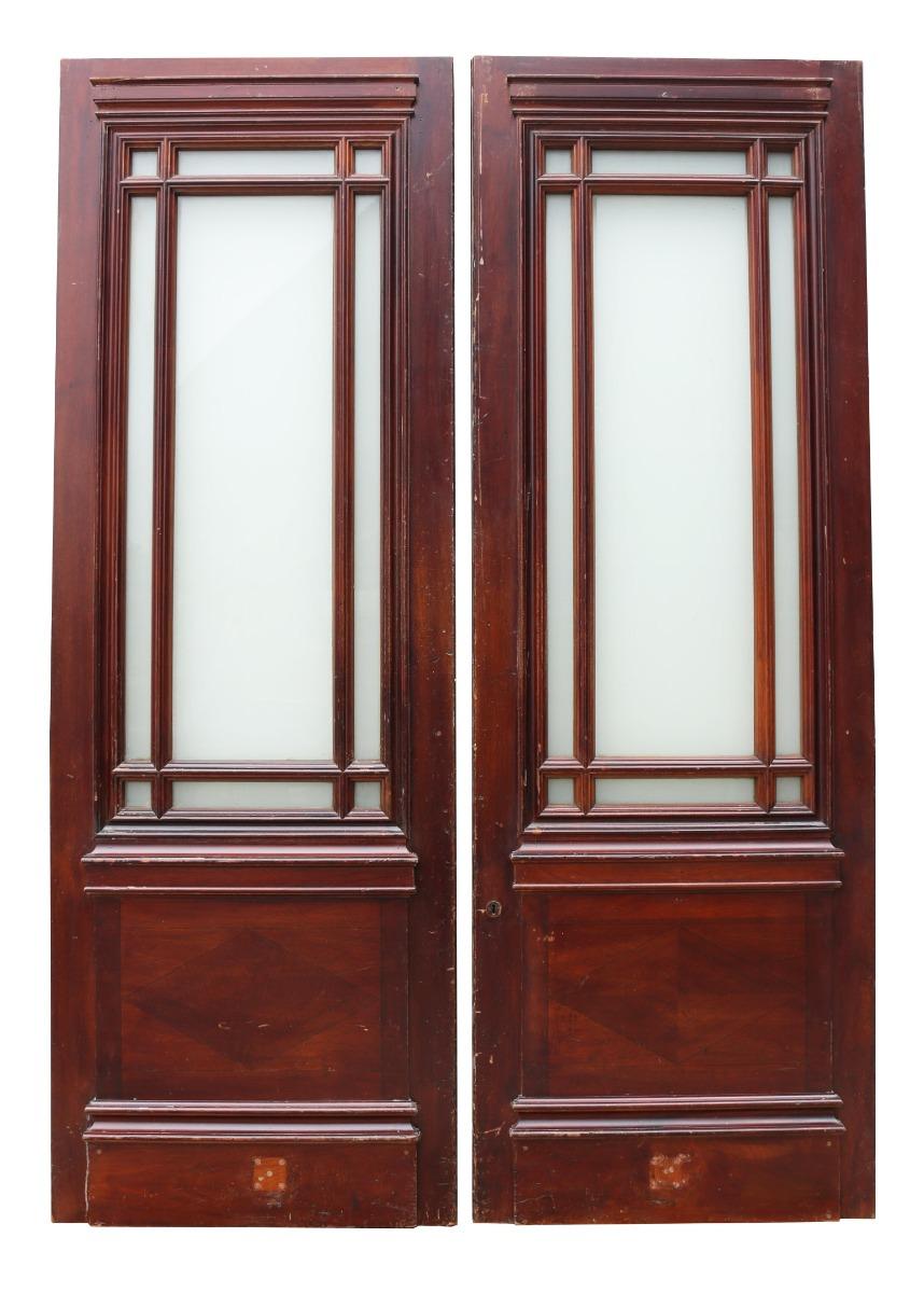 These substantial doors are of mahogany construction, fully glazed with opaque glass and are currently configured as swing doors. Formally used in a London gallery. The opaque glass finish can be removed if required, as this is film applied to clear