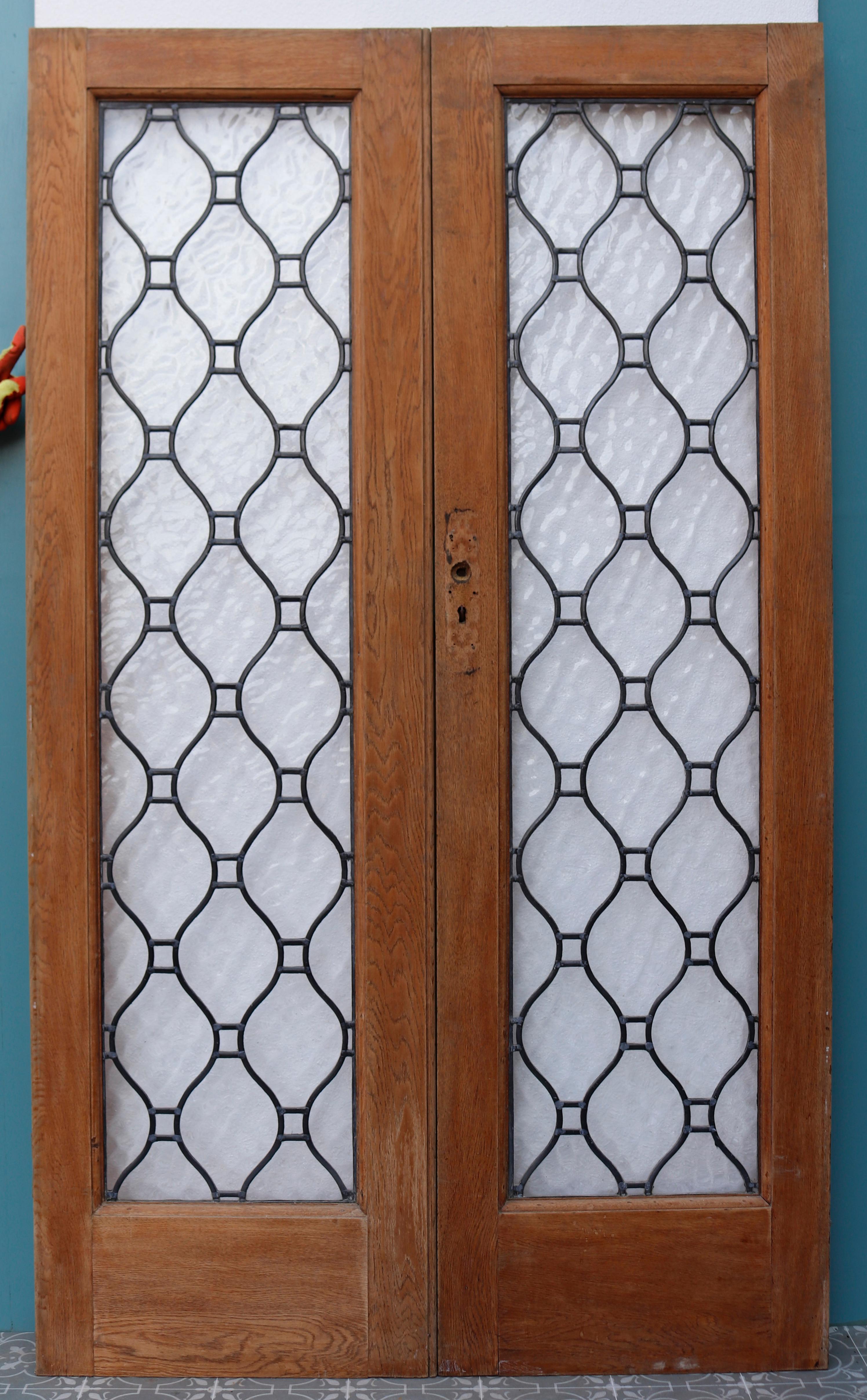 A set of oak double doors with leaded textured glass panels. We have two sets available.
   