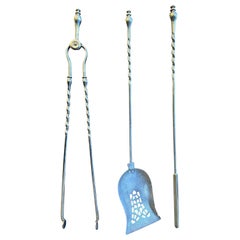 A Set Of Antique Polished Steel English Fire Tools