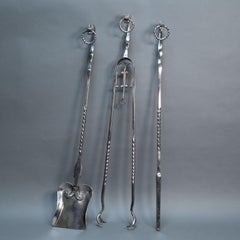 A set of Arts & Crafts Cotswold School polished steel hand wrought fire utensils