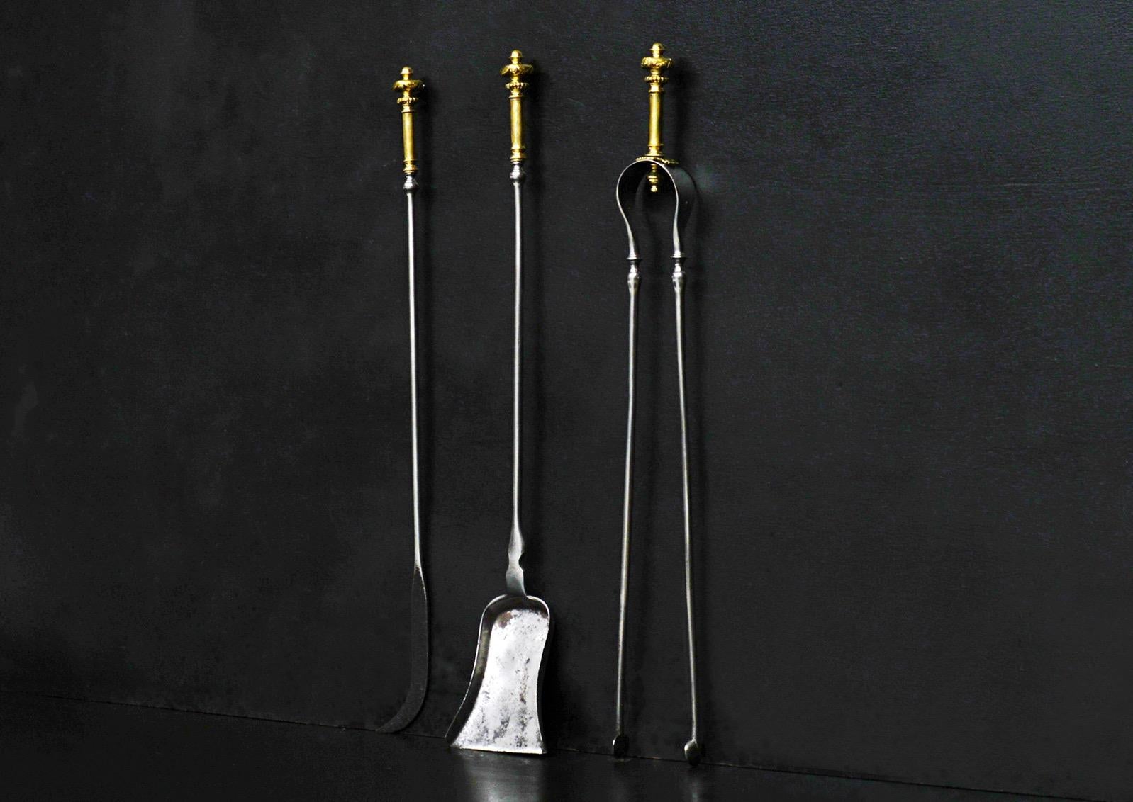 A set of brass and steel firetools. The brass handles with gadrooned finials and tapering shafts below. Solid pan to shovel. English, 19th century.

Length: 675 mm 26 ?
