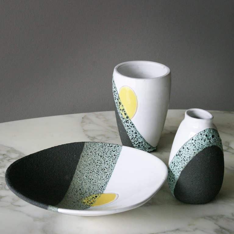 The two vases and the plate offered belong to a limited edition of ‘lava glaze’ ceramic objects commissioned by the prominent Dutch department store ‘De Bijenkorf’ and were manufactured by Bitossi (Montelupo) circa 1958. 
Diameter: 9.84 in. (25 cm)