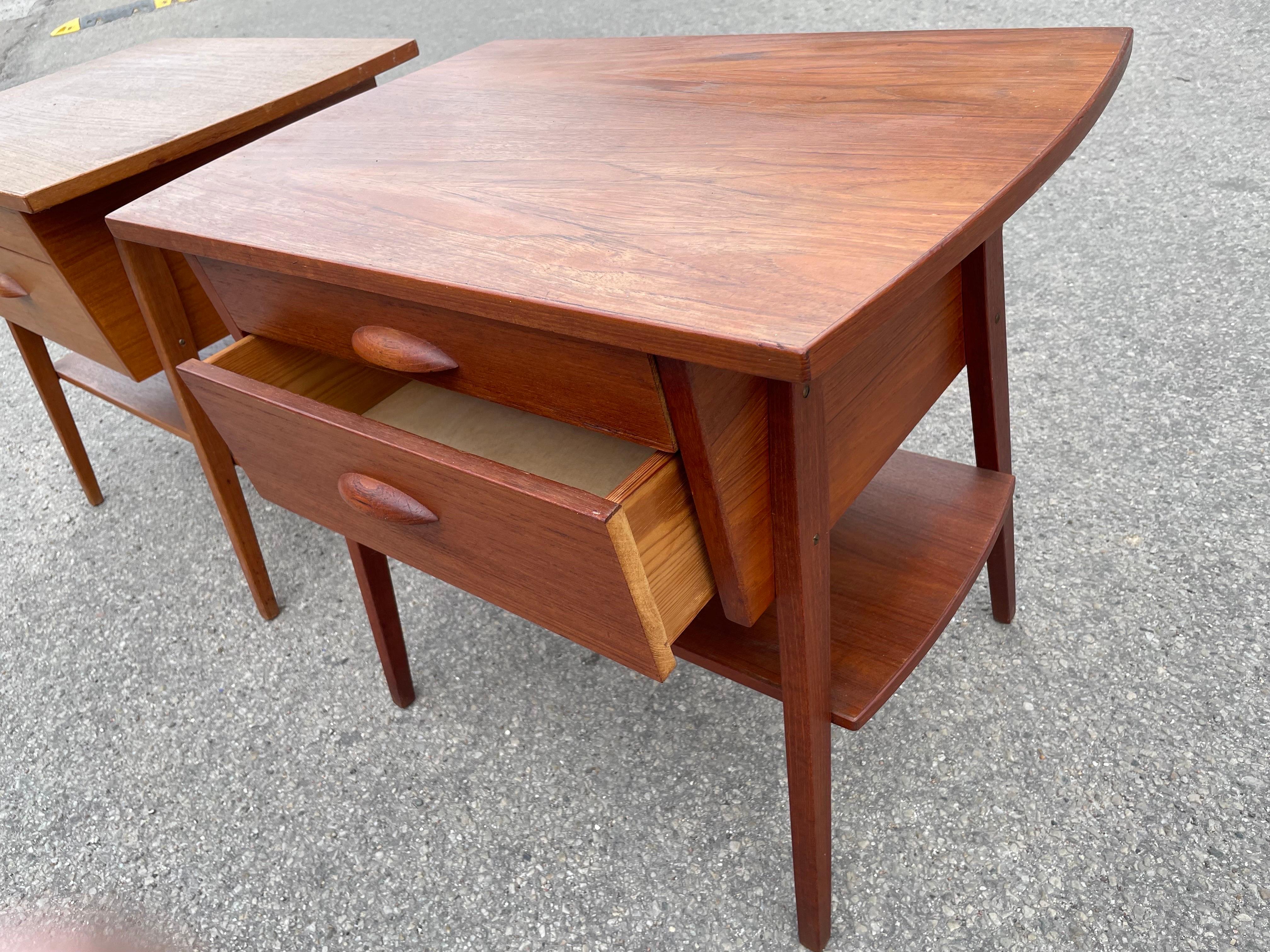 1960s Teak Nightstands. Crafted in Denmark, these sleek and timeless pieces effortlessly blend form and function. Made from exquisite teak wood, each nightstand showcases elegant lines, organic textures, and warm hues. With their compact size and