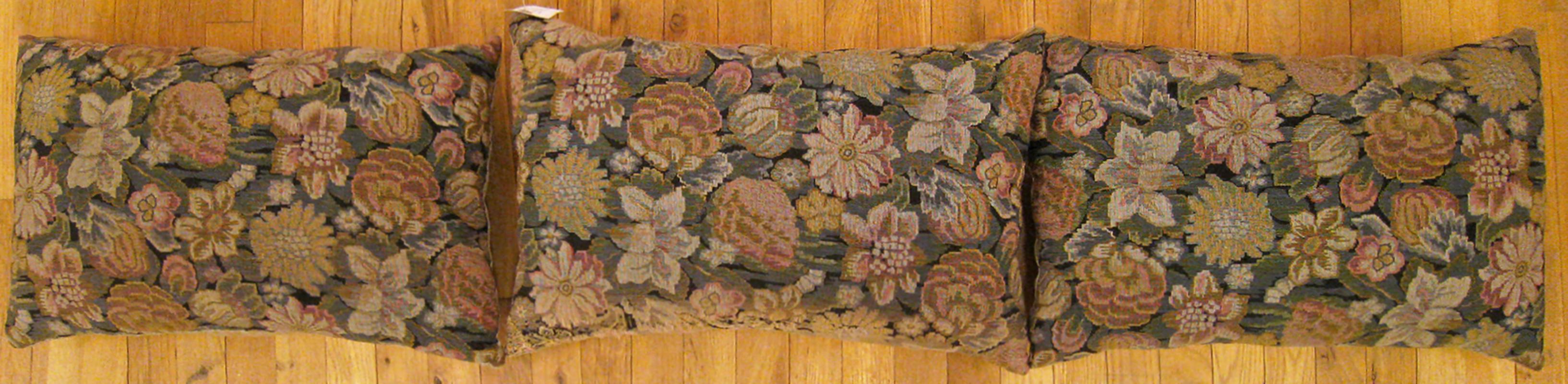A set of antique jacquard tapestry pillows ; size 1'4” x 2'0” and 1'3” x 1'11”.

An antique decorative pillows with floral elements allover a gold gray central field, size 1'4