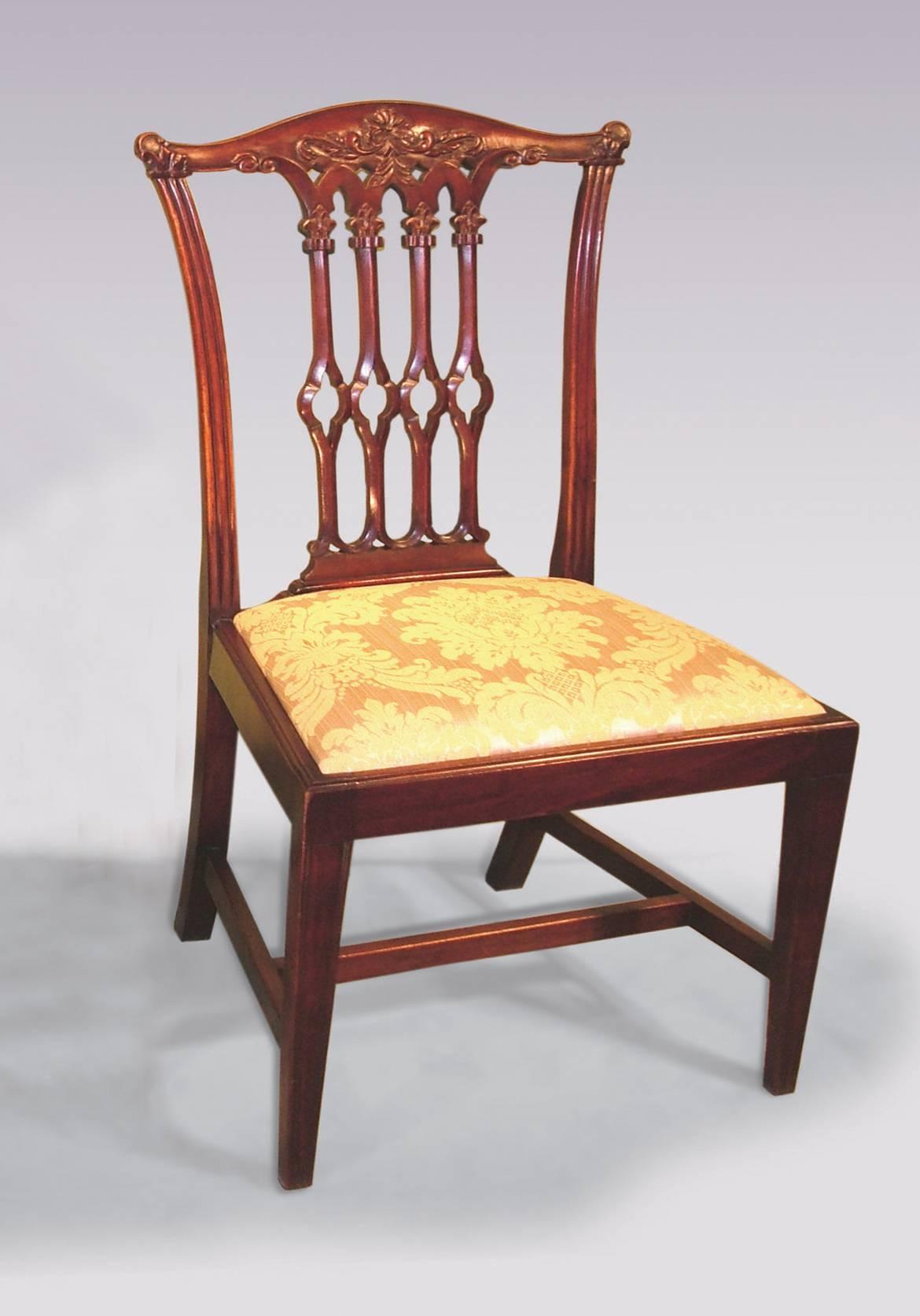 A set of eight 19th century Chippendale style mahogany dining chairs having moulded, floral carved backs with pierced, Gothic, fleur-de-lys carved splats above drop in seats.