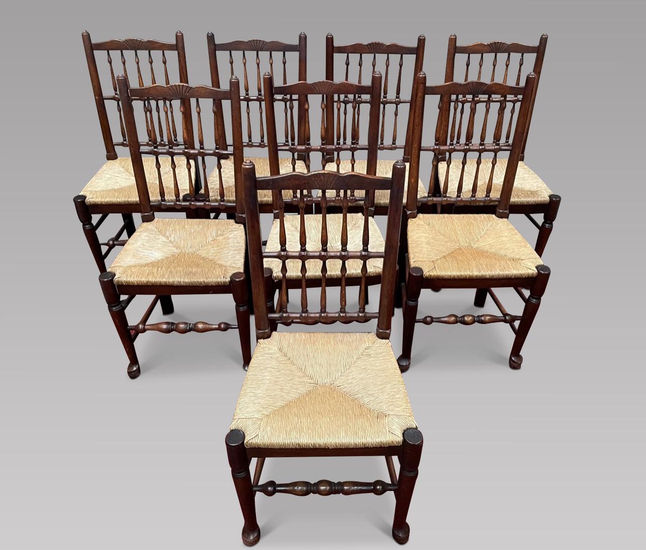 A Set of Eight Elm Spindleback chairs in very good order, with drop-in rush seats, on turned legs joined by stretchers,

Measures: Height Back 96.5 cm, Width 48 cm, Depth Seat 38.5 cm and Seat Height 47 cm.