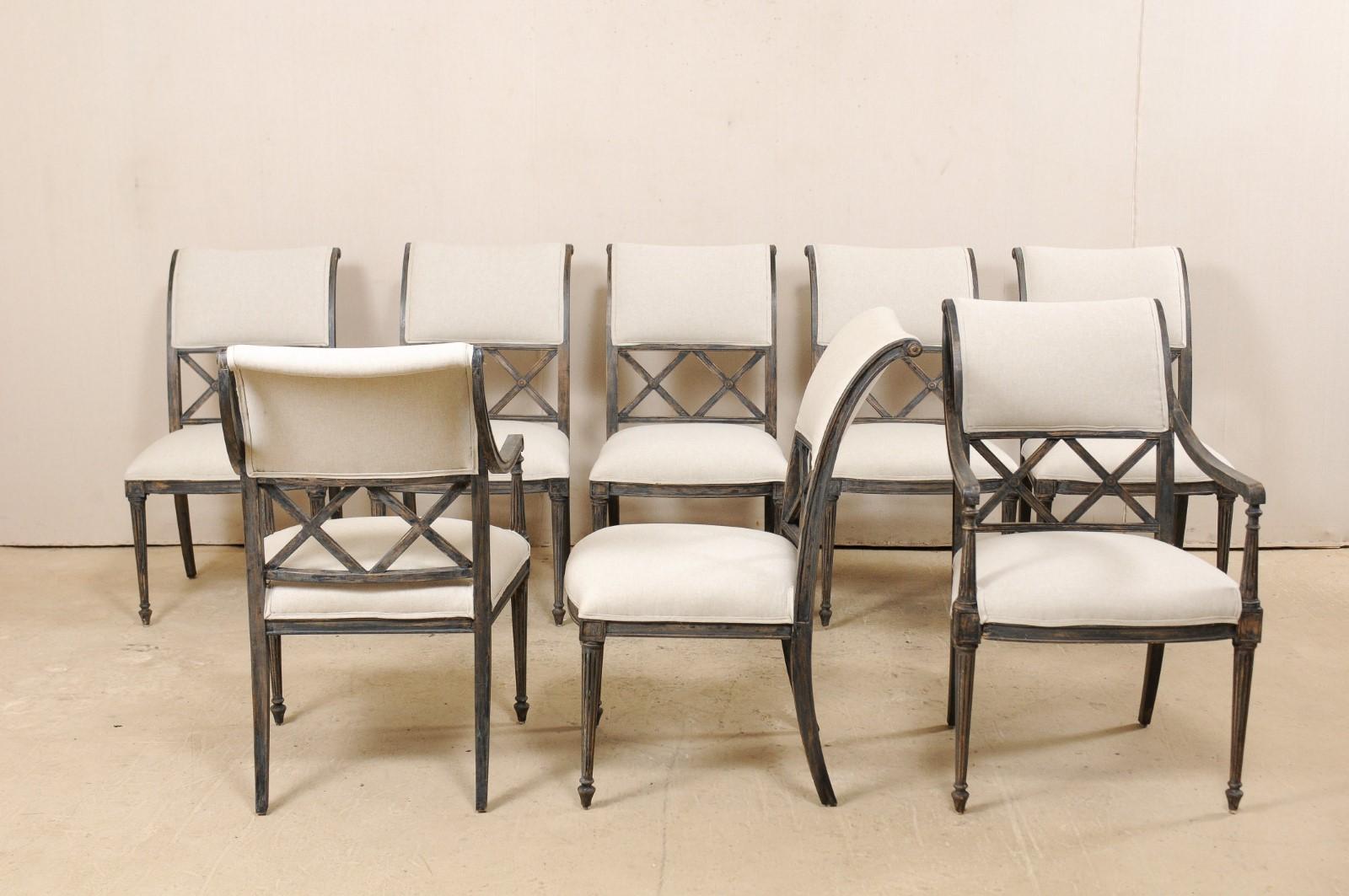 A set of eight Empire style inspired chairs from American furniture makers Henredon. This vintage set of side chairs consist of a pair of arms and six side chairs, each featuring beautifully arched backs, pierced double x-shaped pattern adds an airy