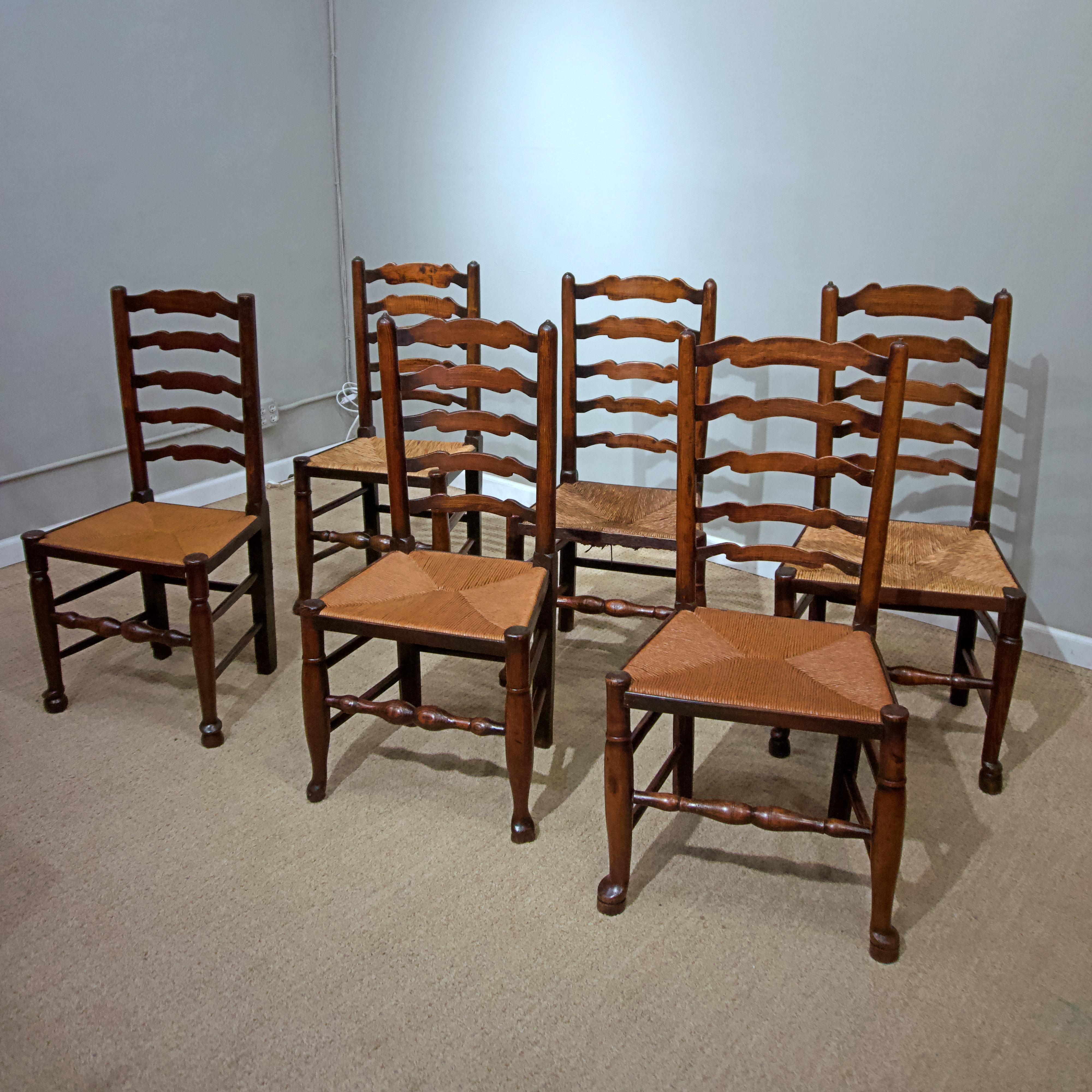 A set of eight English oak ladder back chairs with rush seats
with slight variations in design & heights.

Seat dimensions 
Height 17.5th
Depth 16’’
Width 21’’