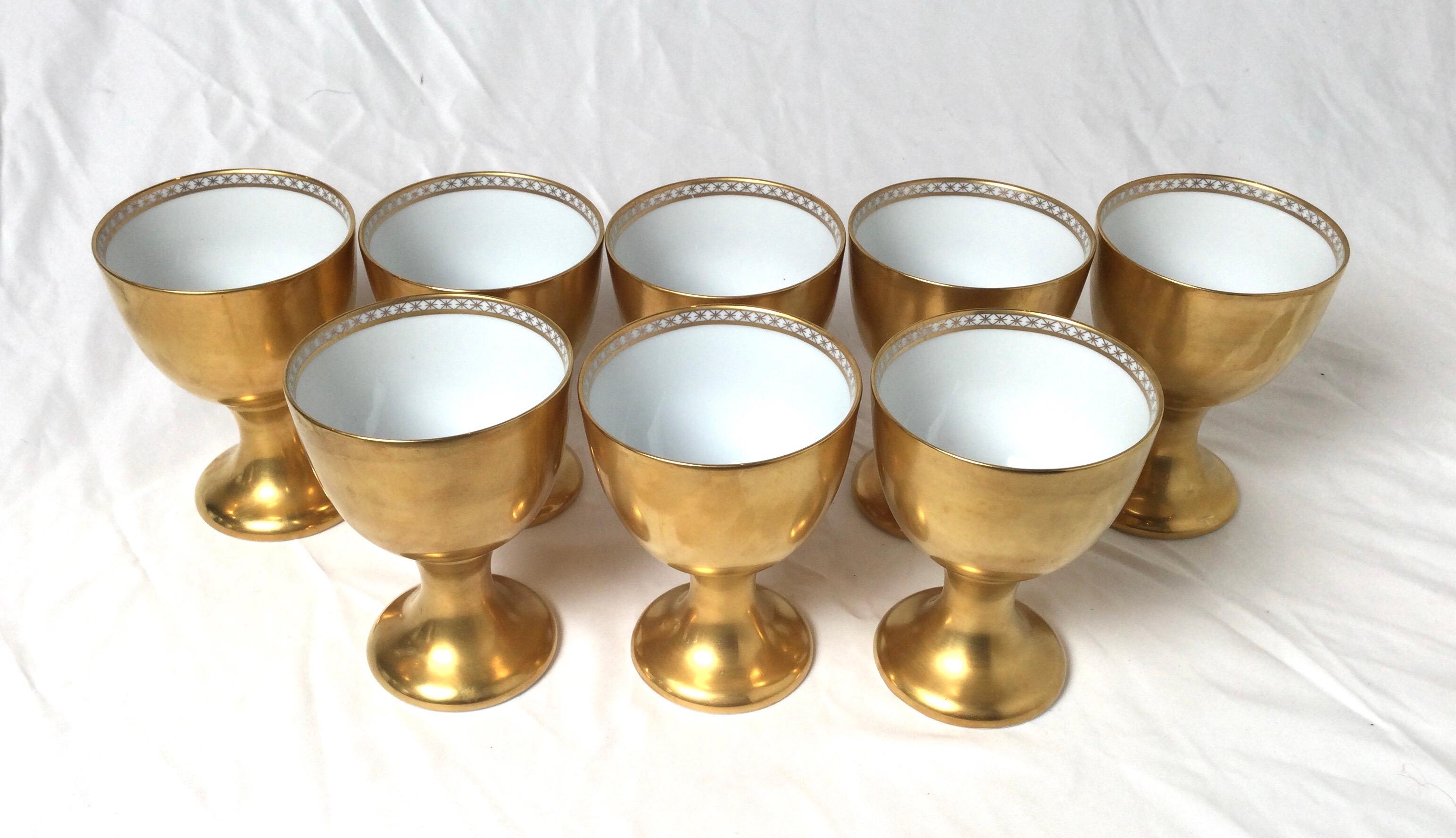 Eight porcelain all over gilt chalice form goblets, by Fitz and Floyd Circa 1978. White porcelain with sold gold decoration.
