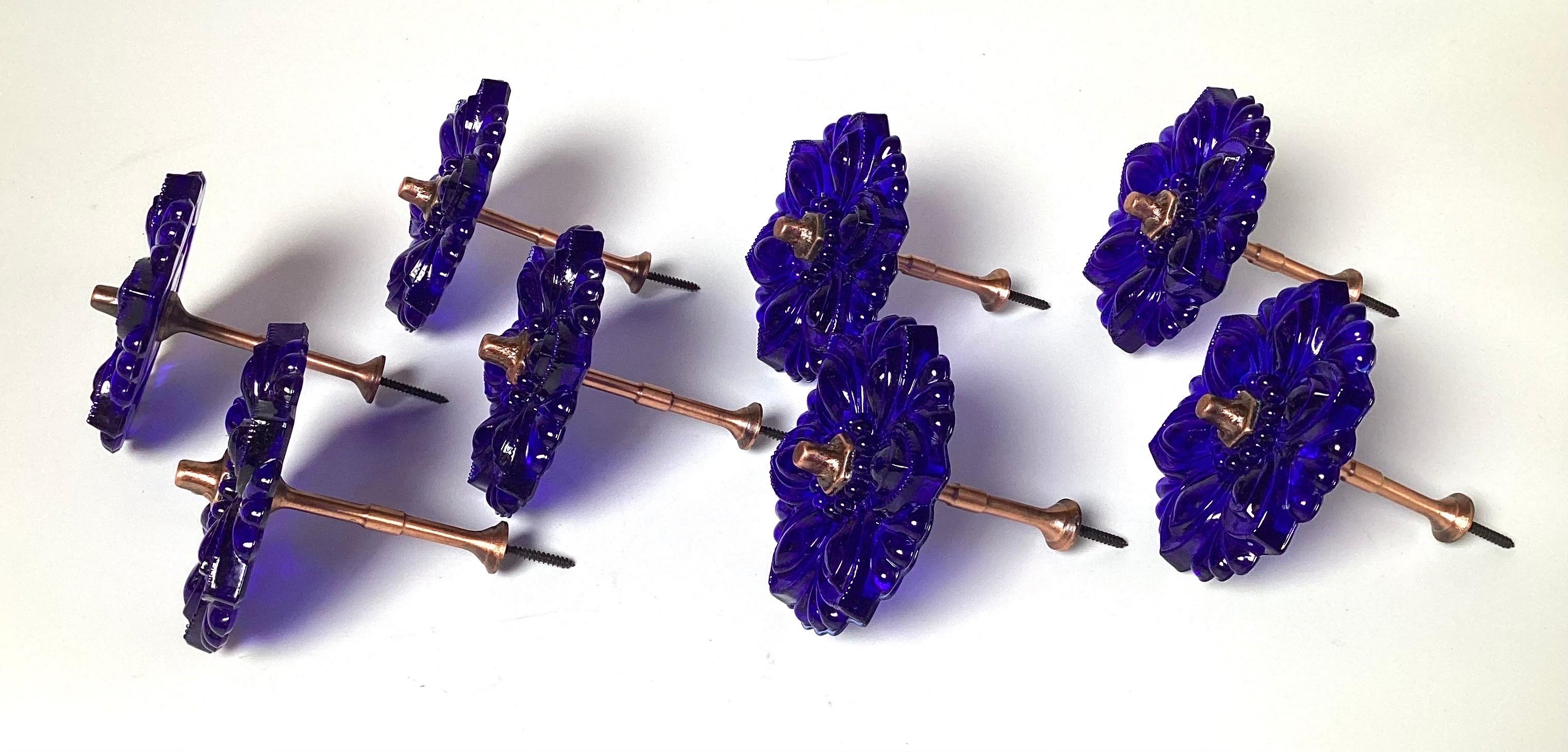 A set of eight pressed cobalt glass rosette drapery tie backs.