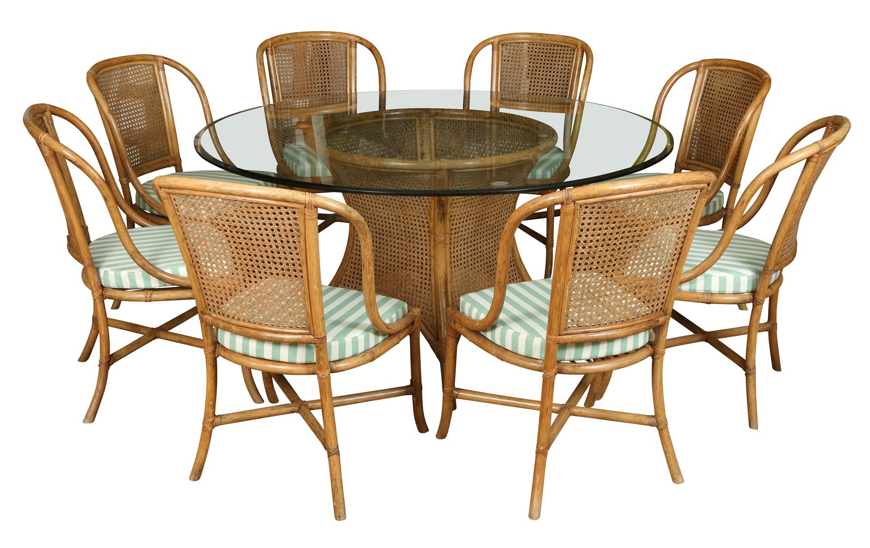 A chic set of rattan dining chairs with curved, caned backs and cross stretchers. The new custom removable seat cushions are in a cheerful green and white stripe.