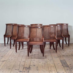 A Set of Eight Regency Mahogany Caned ‘Barrel Back’ Dining Chairs