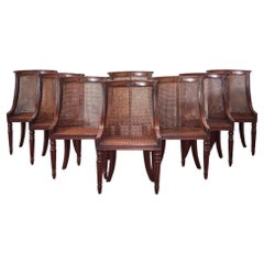 A Set of Eight Regency Mahogany Caned ‘Barrel Back’ Dining Chairs