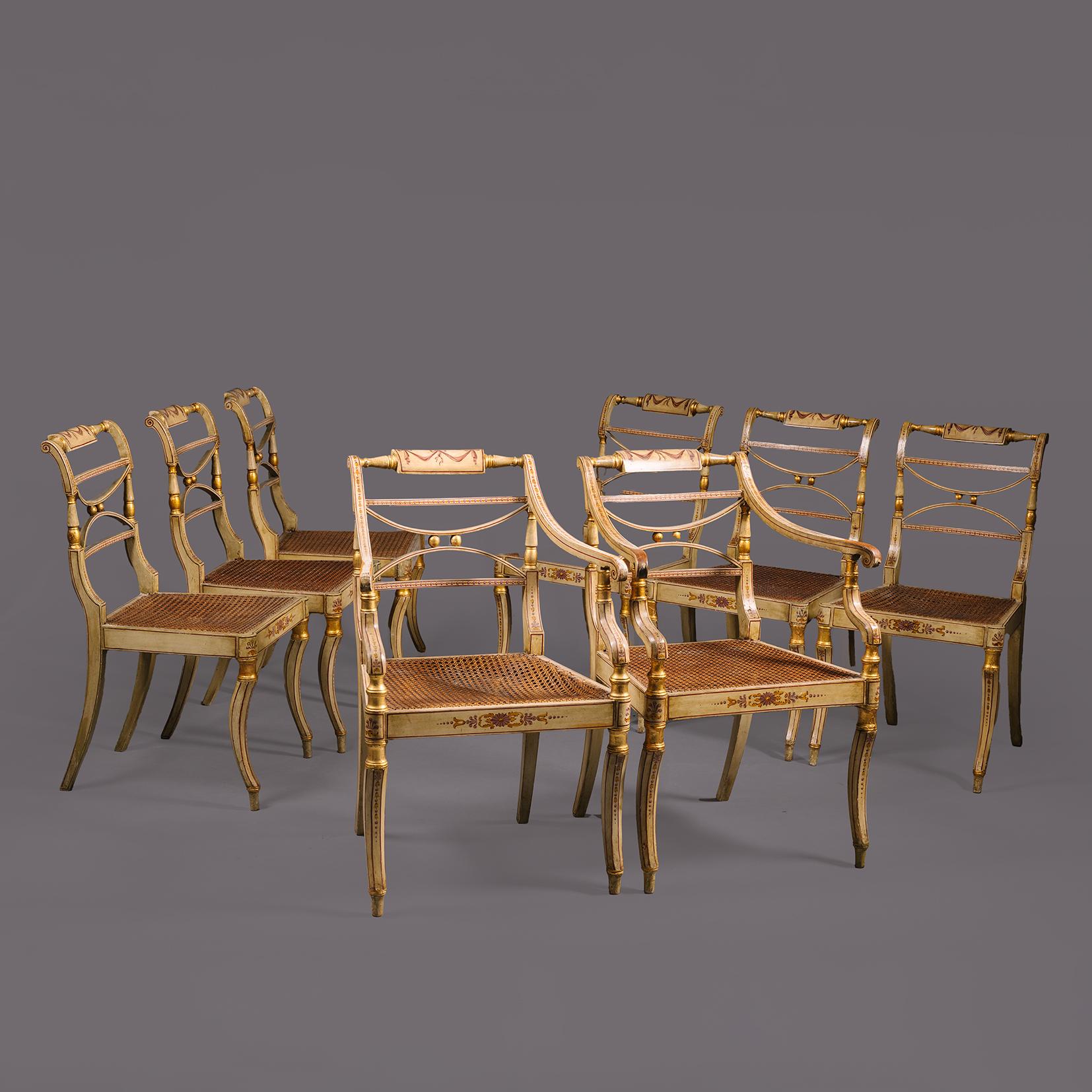 Ein Satz von acht polychrom bemalten und paketvergoldeten Regency-Esszimmerstühlen. Nach dem Vorbild von John Gee.

Bestehend aus einem Paar offener Sessel und sechs Beistellstühlen. Alle mit cremefarbenen Mahagoni-Rahmen, verziert mit Tressen und