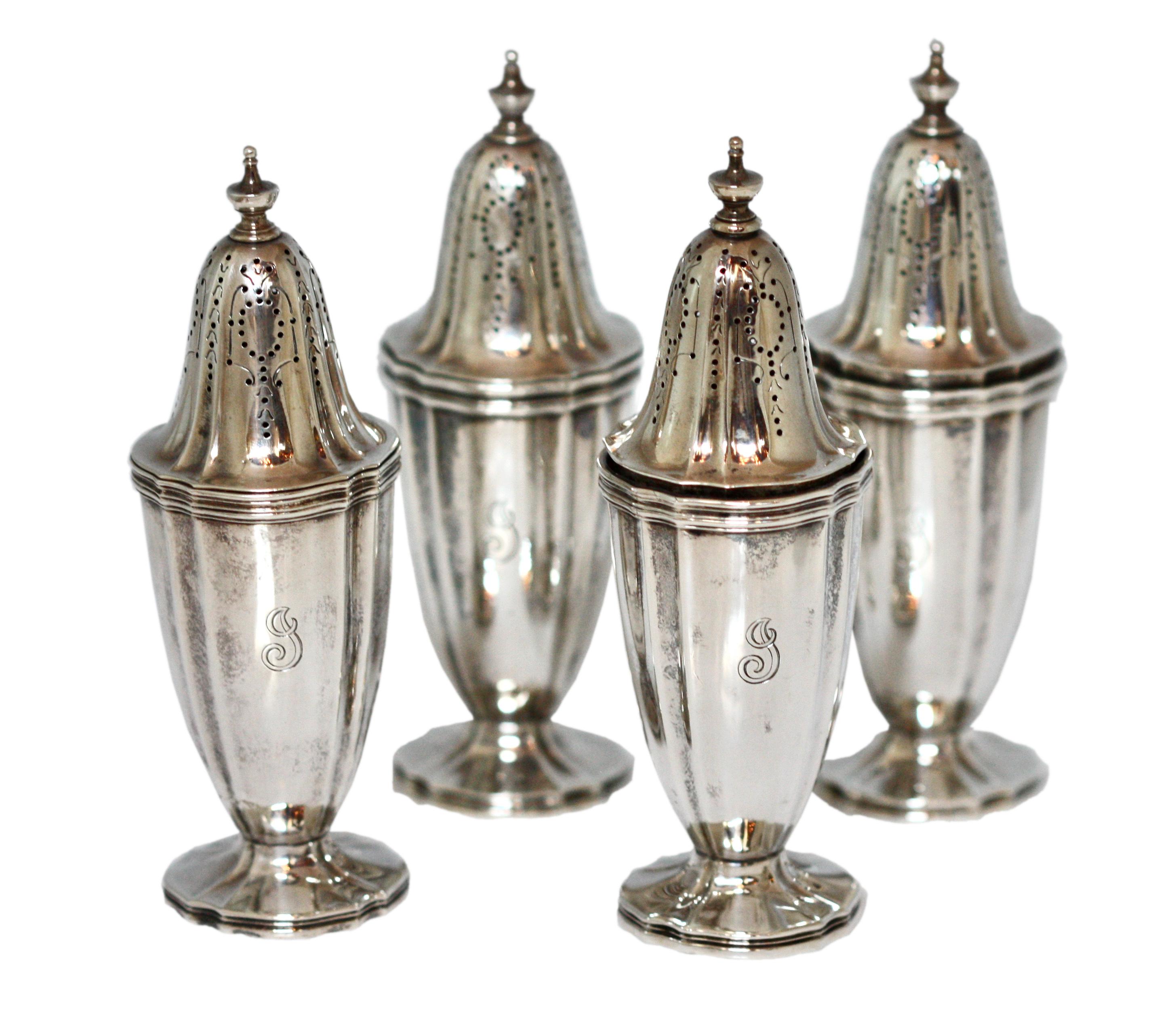 A set of eight, Tiffany & Co., sterling silver open salts & pepper shakers, 1907-1938, comprising four shakers and four salts, with shaped foot and fluted body, monogramed G
each marked underneath:
TIFFANY & CO. MAKERS
STERLING
925/1000
height