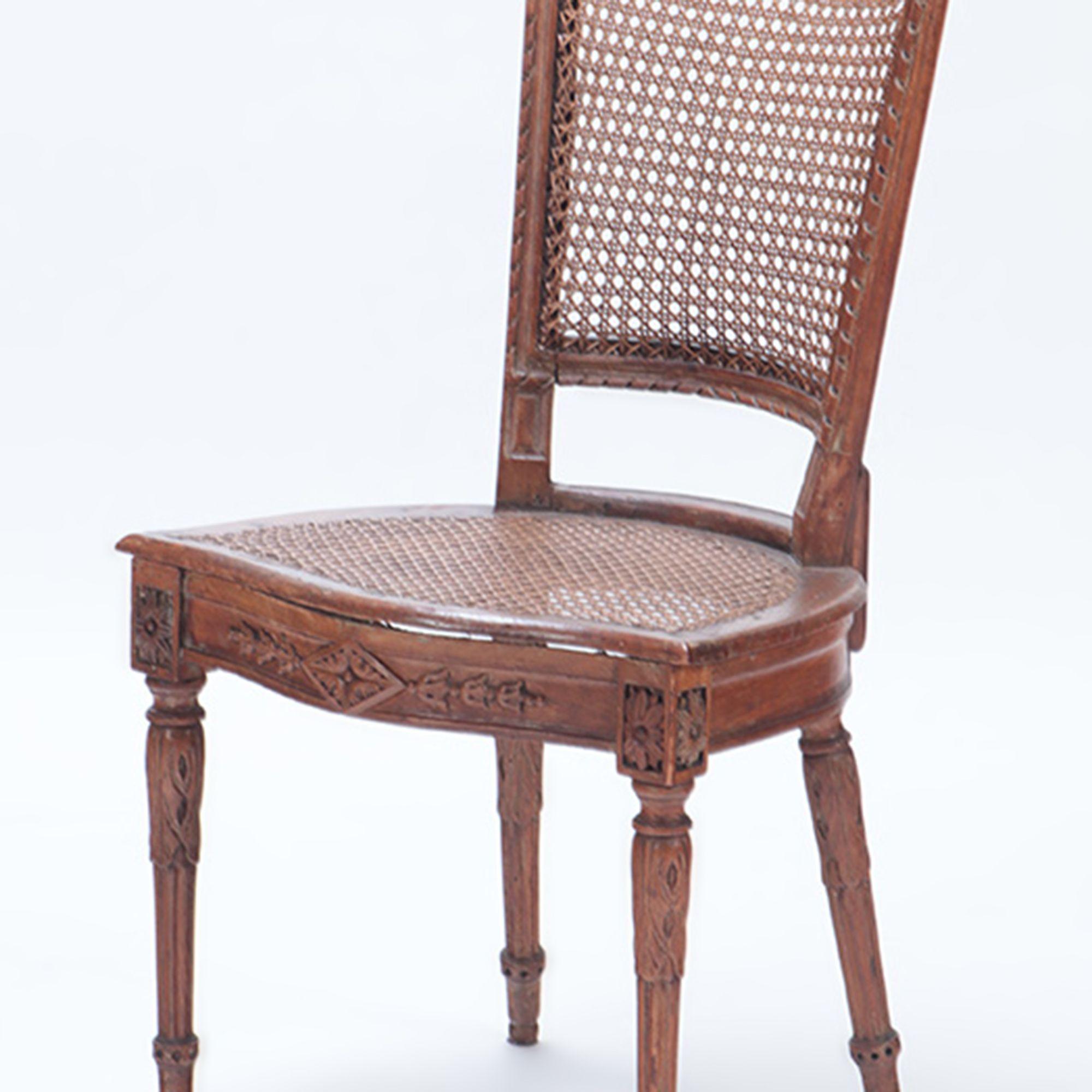 A set of Eight carved walnut and cane dining room chairs with loose cushions, tapering legs, early 19th century.