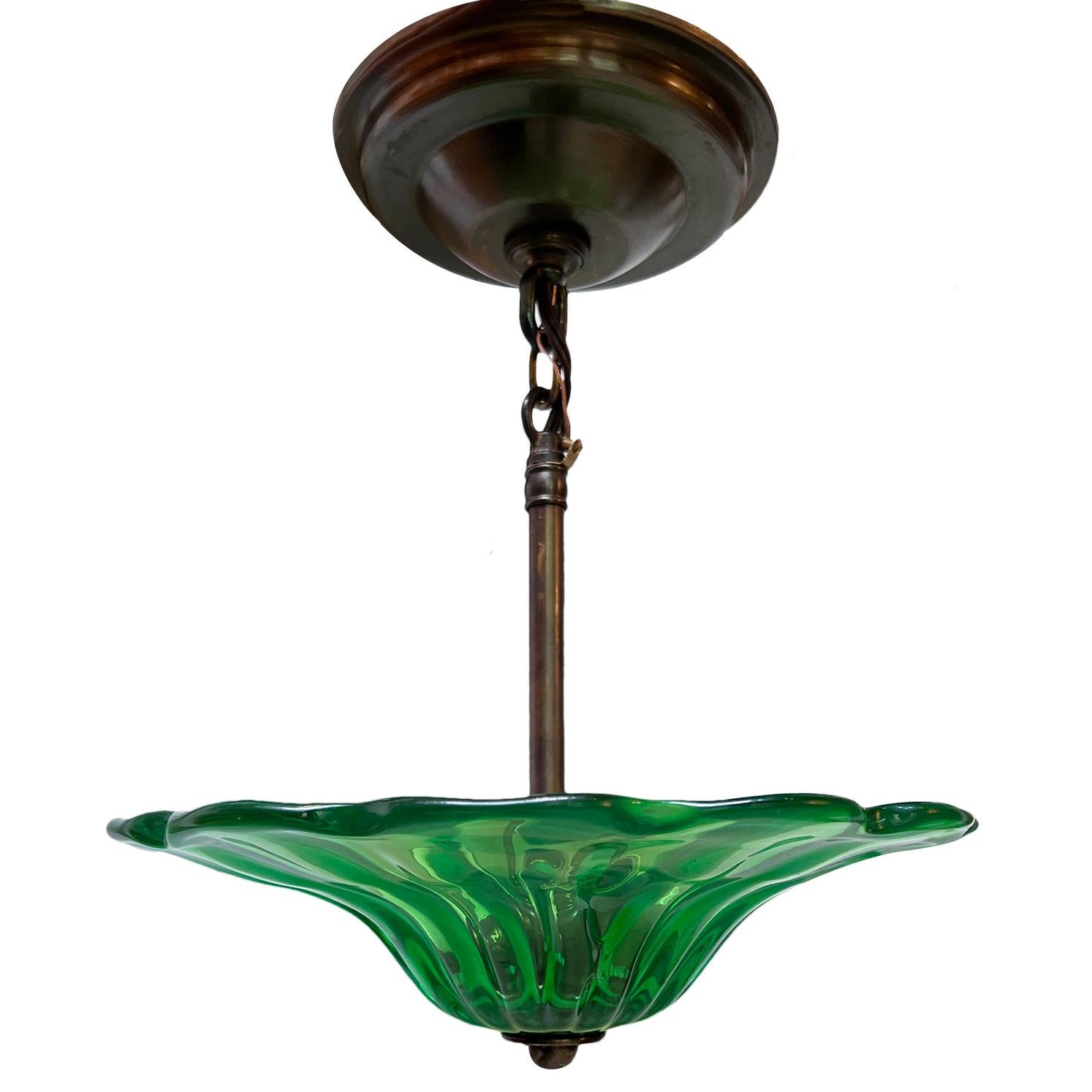 A set of three circa 1930's blown emerald green Murano glass light fixtures with 3 candelabras interior lights.

Measurements:
Diameter: 10.75