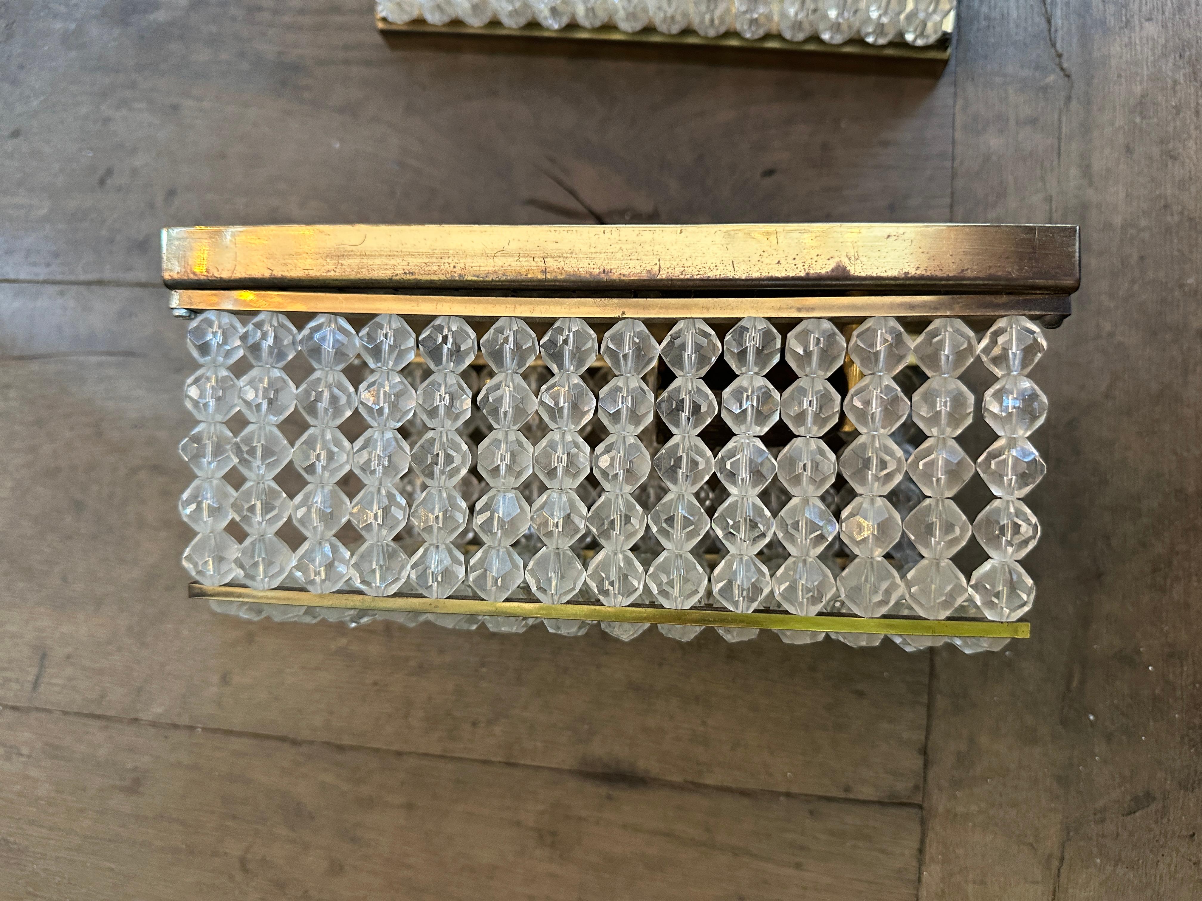 A set of three brass and lucite wall lights by Emil Stejnar for Rupert Nikoll 
Each light fitting with one bulb inside, light refracting from brass back plate and held with and through the lucite pieces. 

Mid century Austrian 