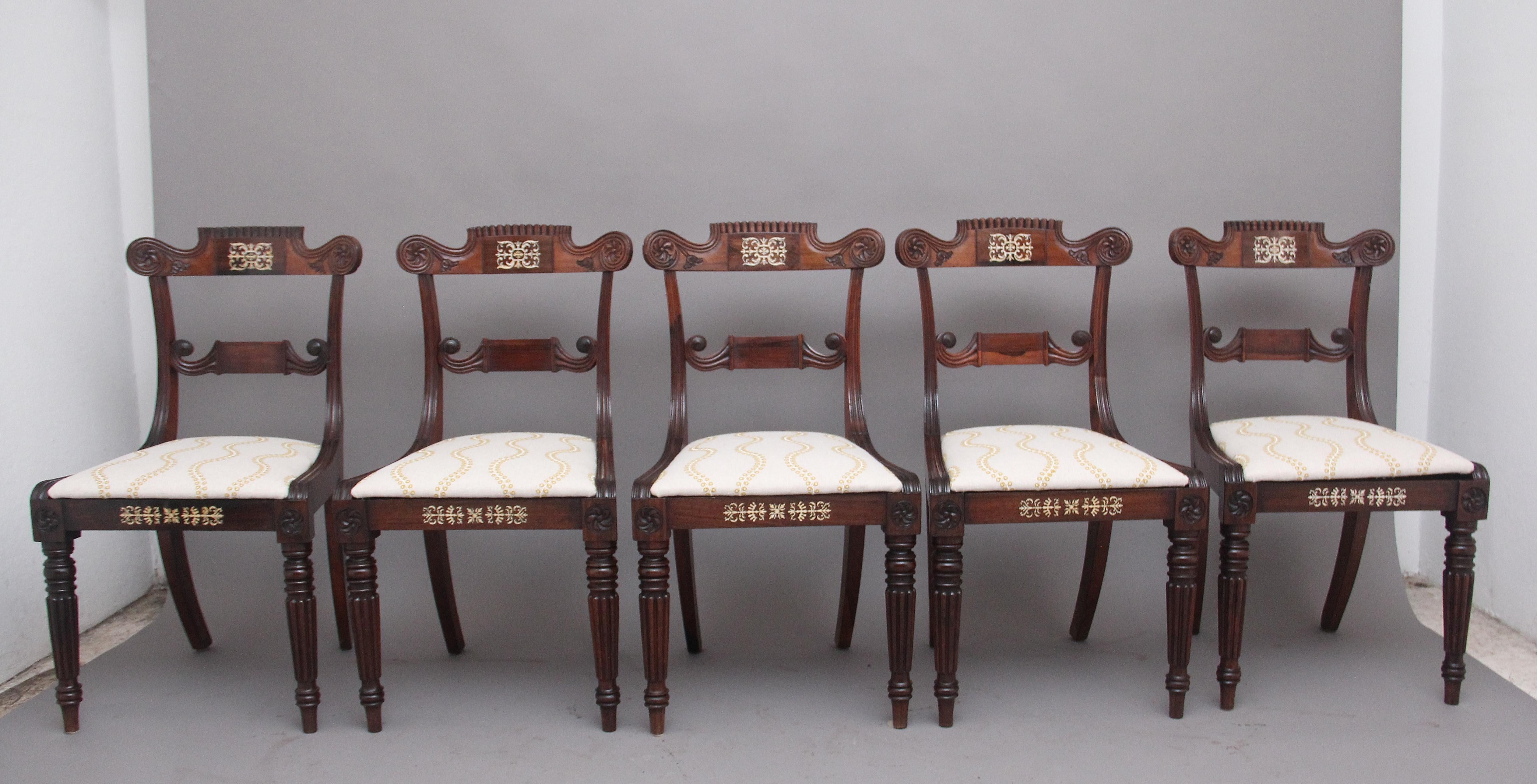 A set of five early 19th Century Anglo Indian rosewood side chairs, having a highly decorative shaped back rail incorporating a central panel with bone inlay and floral carving at either side, carved middle rail with shaped side rails, a recently