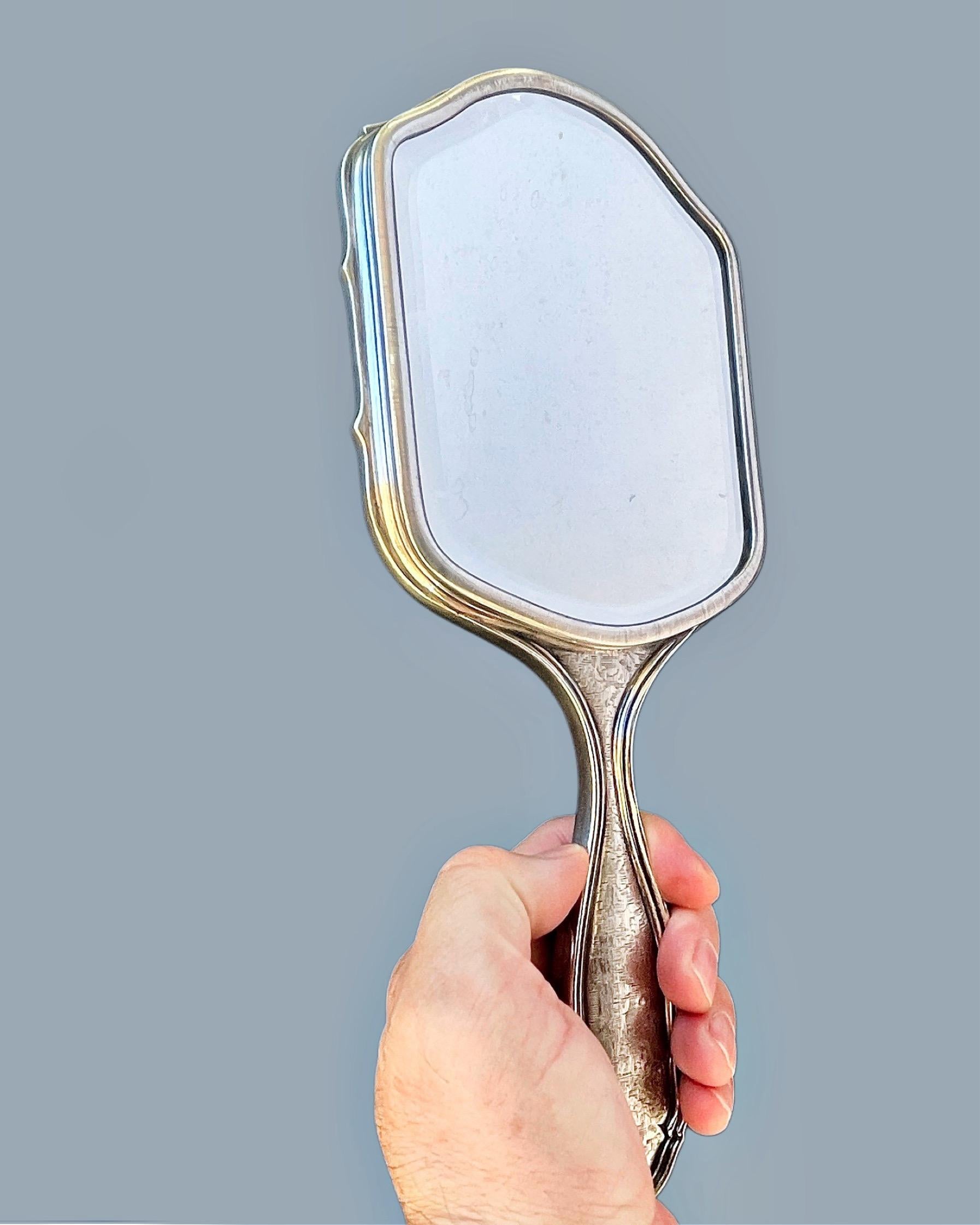 A set of five silver vanity items by Buccellati, including a handheld mirror, a large hair brush, a large clothing brush, a smaller clothing brush, and a comb, Italy 20th century. All signed Buccellati Italy 800.

1. the mirror measures approx. 11