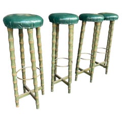 A set of four 1950s Spanish Faux bamboo wooden and brass stools