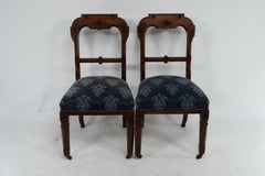 A set of four Aesthetic Movement oak dining chairs with carved decoration