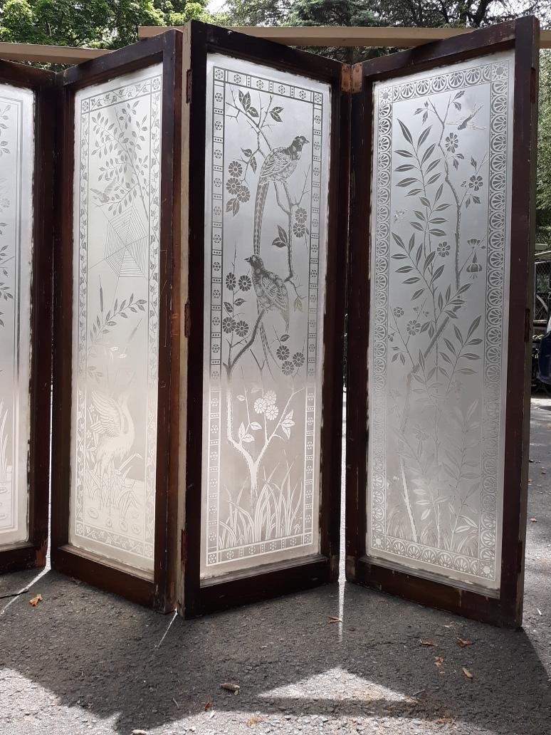 A set of four aesthetic movement engraved gall windows in original wood frames. The window panes with birds, insects and spider web, The wood frames with old layers of paint. These panes removed from a Northern New Jersey mansion. Each window