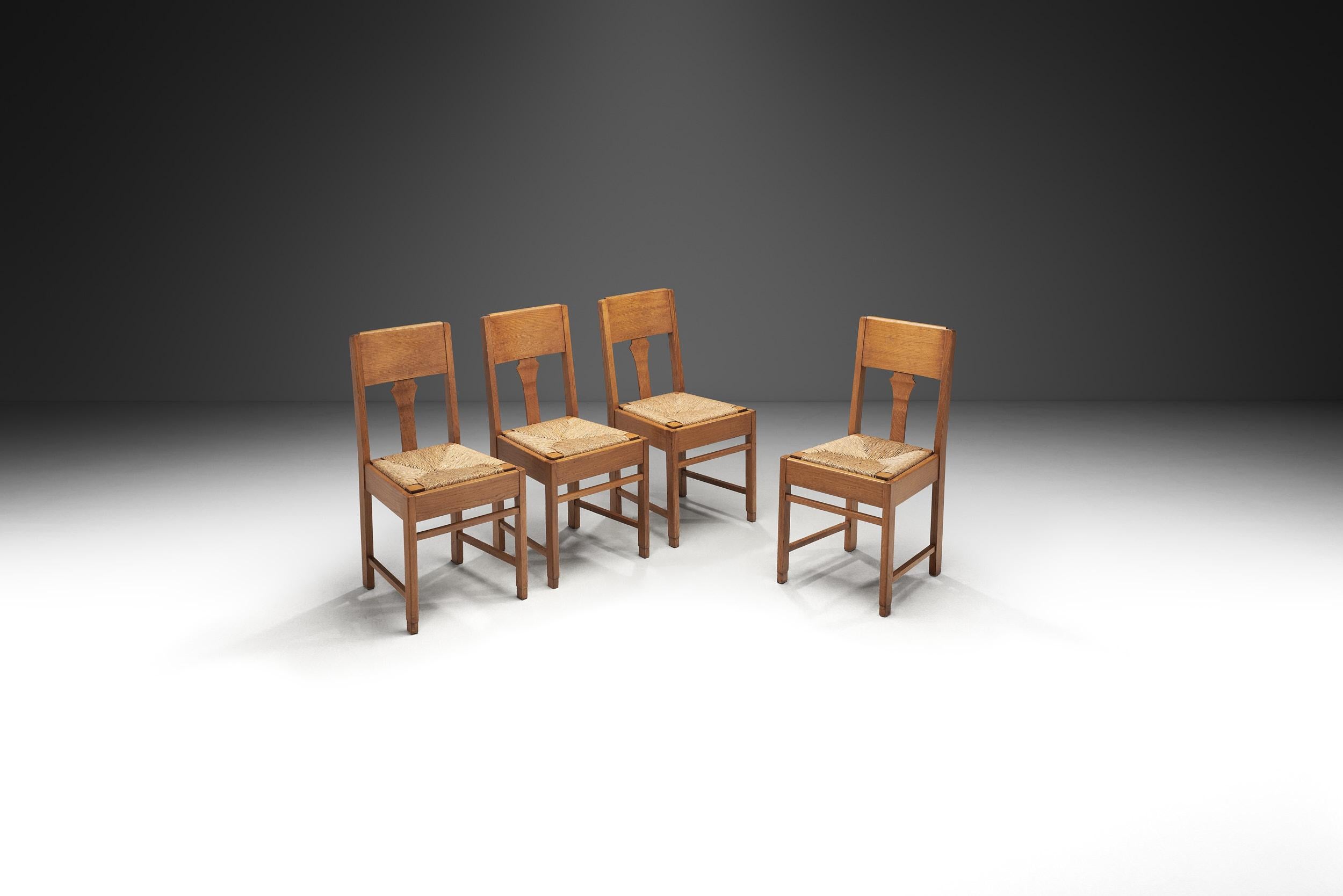 Crafted during a time when movements like Art Deco and Modernism were reshaping design worldwide, this set of four early 20th-century dining chairs reflect a transitional style rooted in both simplicity and elegance. This era emphasizes clean lines,