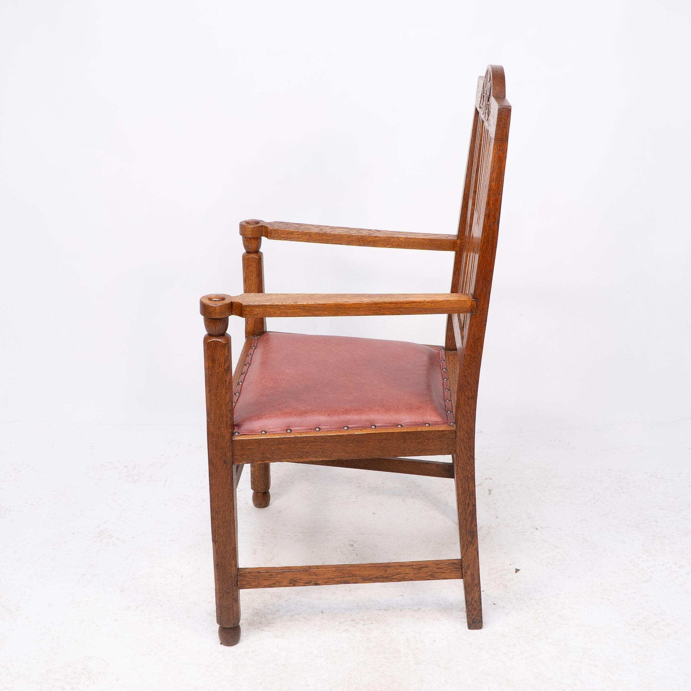 Leather A set of four Arts and Crafts dining chairs with nicely carved floral decoration For Sale