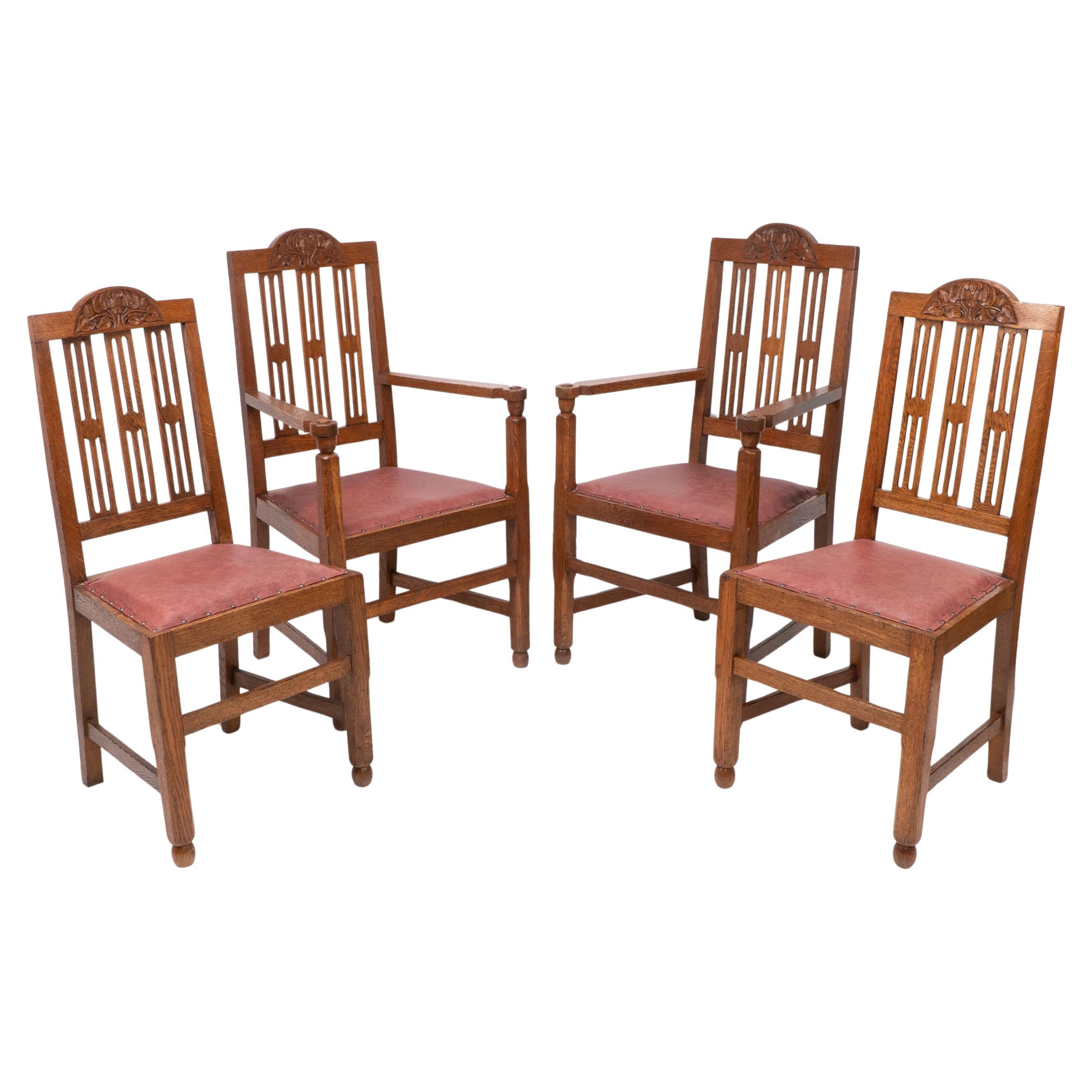 A set of four Arts and Crafts dining chairs with nicely carved floral decoration For Sale