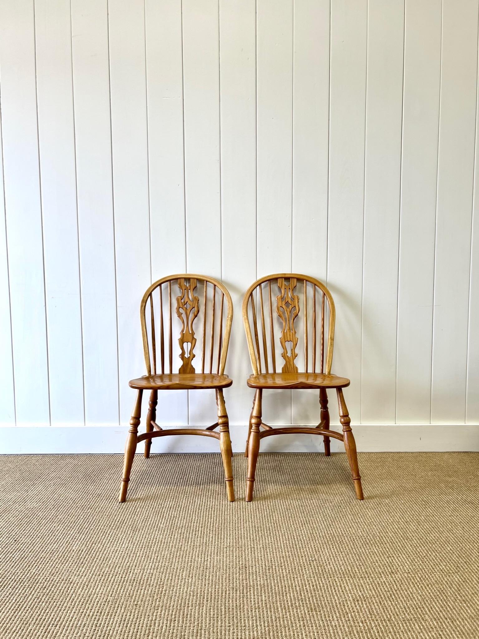 A good set of 4 ash crinoline stretcher Windsor chairs. Lovely honey blonde color. Beautiful pierced back splats.  Very solid and sturdy. These are not antiques. Built the old fashioned way in England. Perfect around a farmhouse table!   A feature