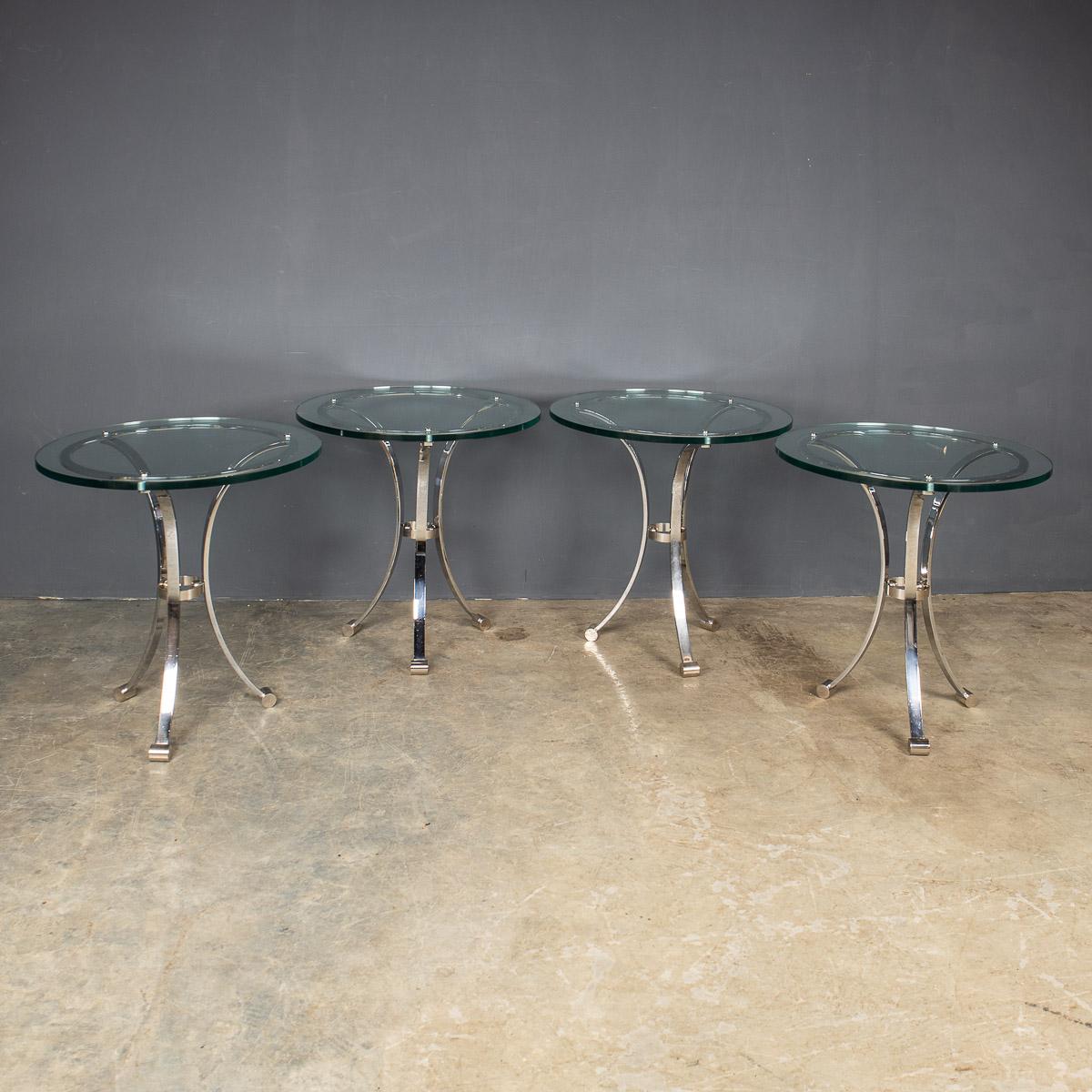 Stylish mid-20th Century set of four sleek bar tables with polished metal legs and heavy glass tops. These elegant side tables once adorned the bar of the Waldorf Hotel in New York, circa 1940’s.

Condition
In good condition - wear consistent