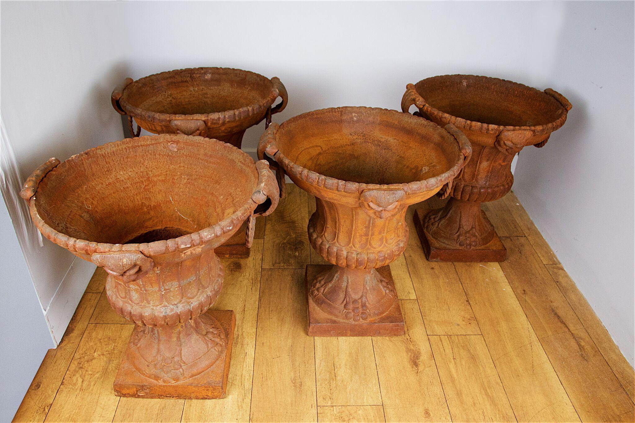 A set of six cast iron garden vases, after the antique, 20th century.