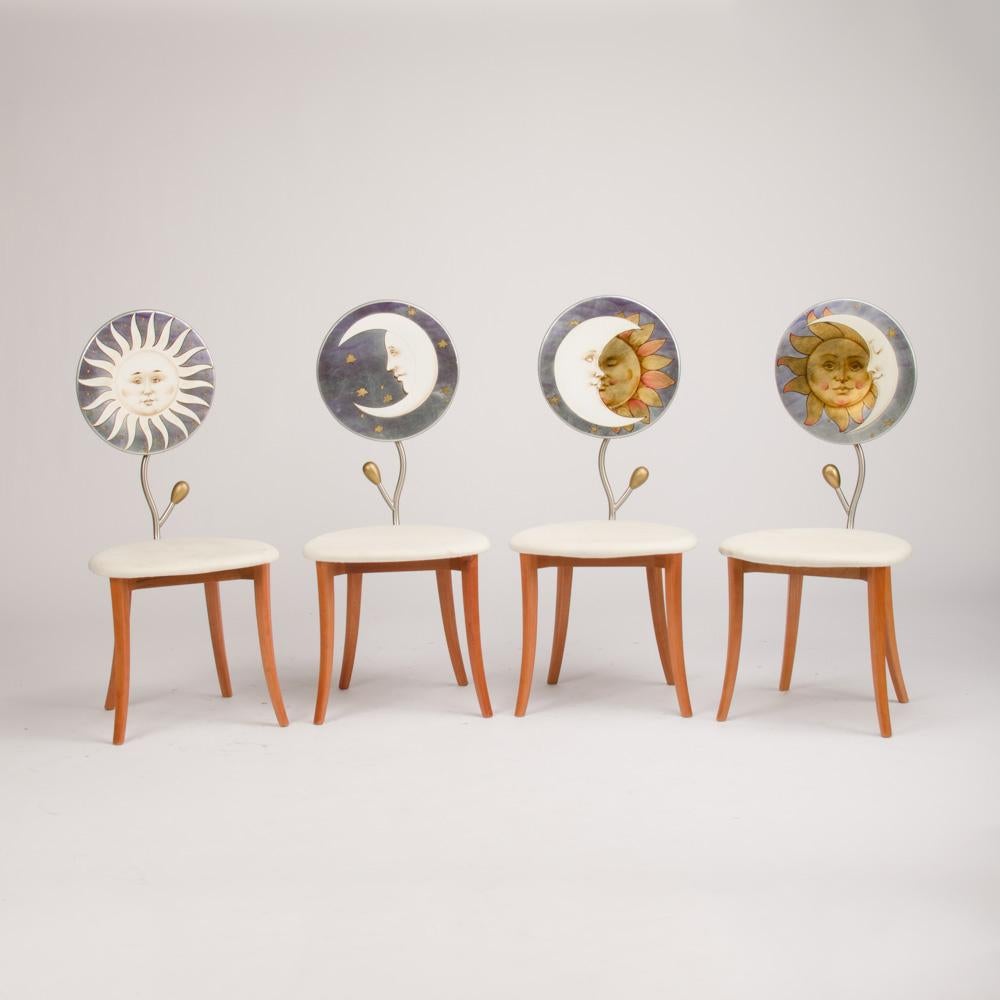 A set of four highly decorative painted iron chairs and a hand painted table with sun drawing, resting on a heavy metal base, circa 1985.
Measures: Table: 30