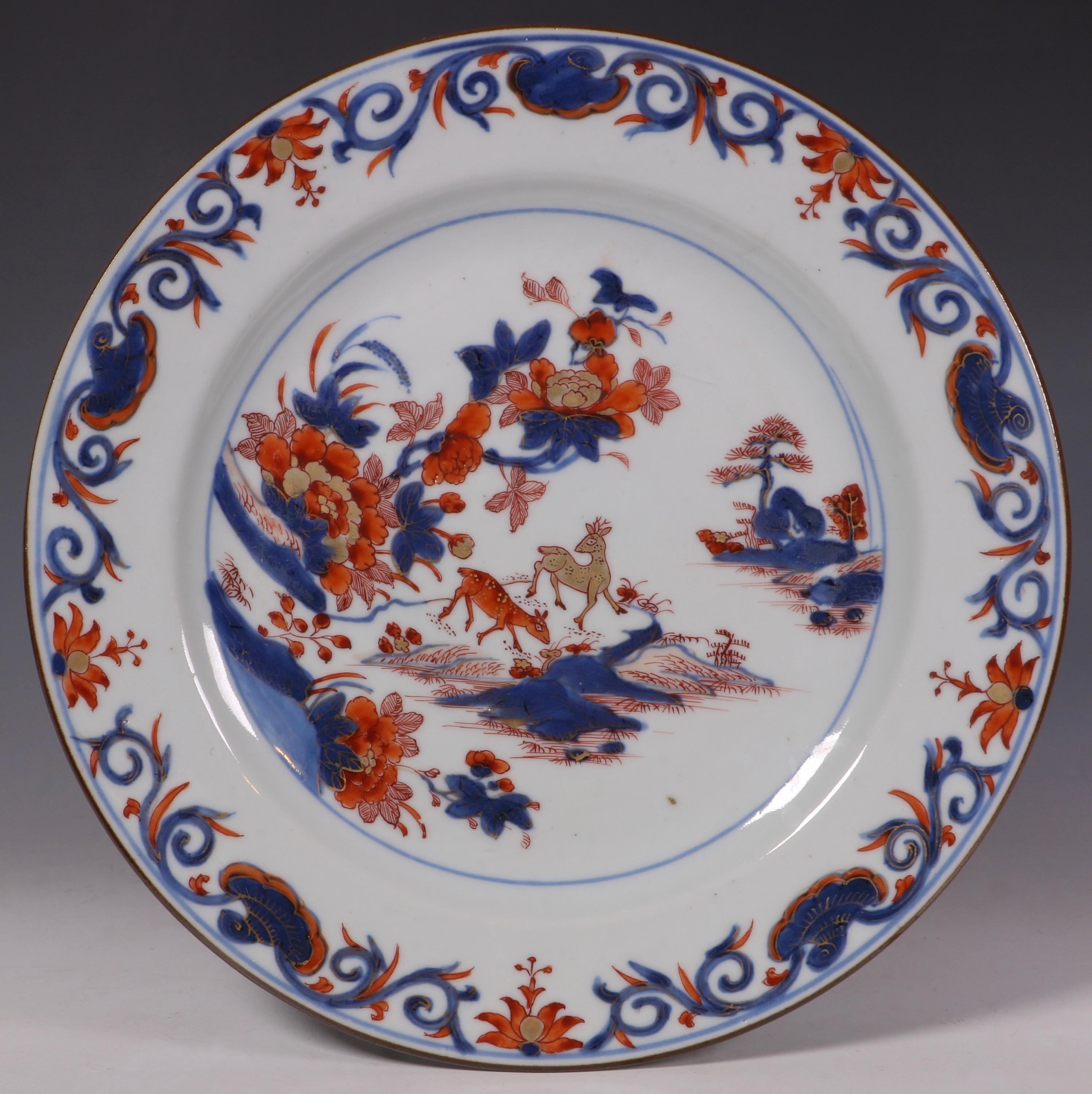 An attractive set of four Chinese Imari plates. Decorated with two deer standing on a rocky promontory below flowering peony. Qianlong, circa 1740.