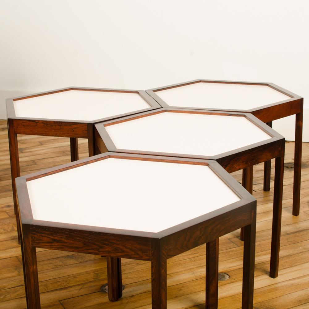 A set of four Danish side tables designed by Hans C Andersen. Hexagon shape with solid rosewood and white formica top circa 1960. Original stamp on each stool.
    