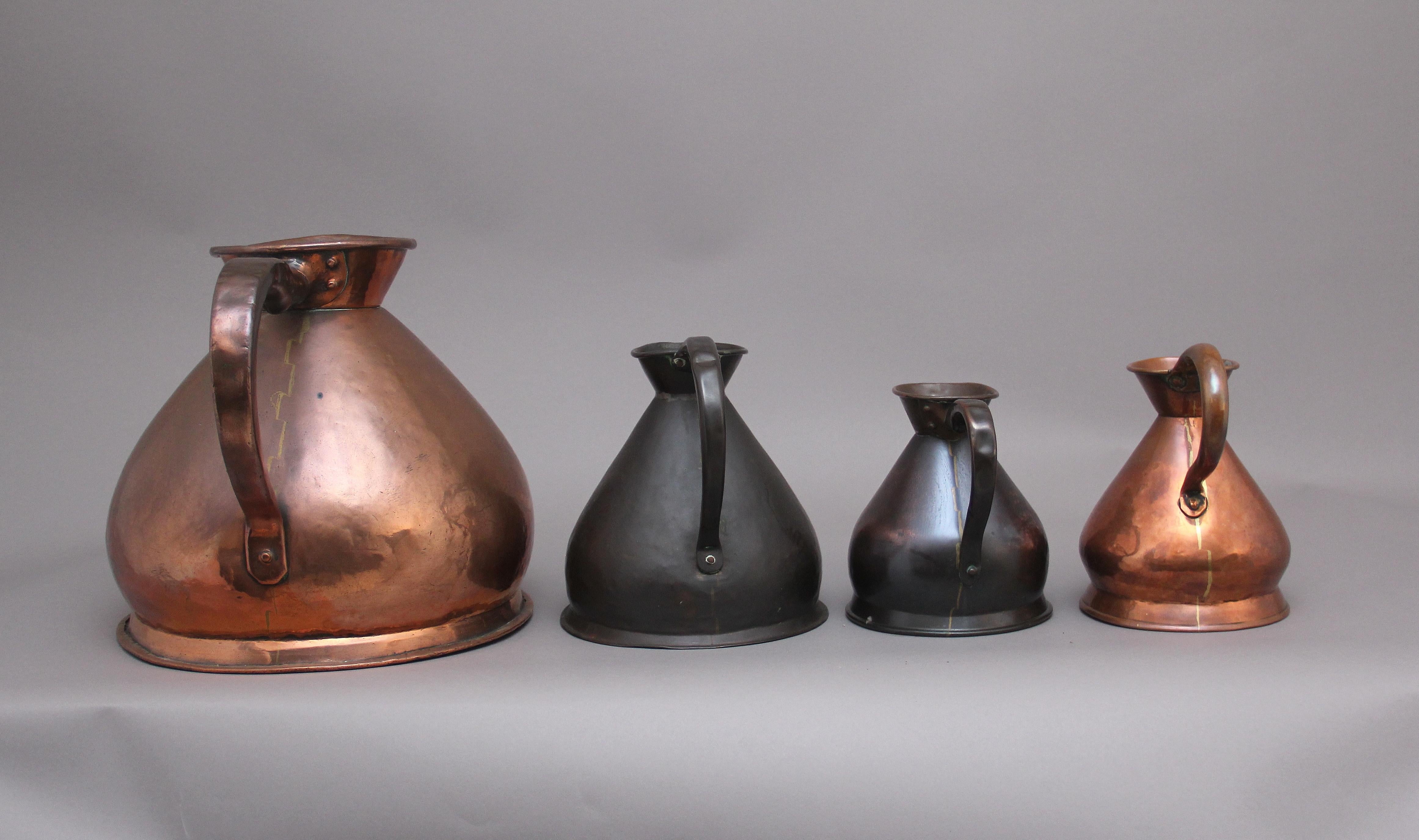 A set of four decorative 19th Century copper measuring jugs, all in very good condition and are marked by how many gallons each one have, in the collection there are 1 x four gallon, 1 x one gallon and 2 x half gallon. Circa 1870.