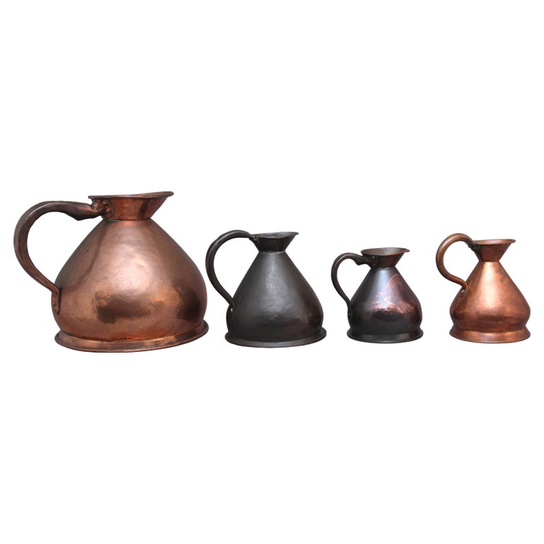 Set of Four Decorative 19th Century Copper Measuring Jugs For Sale at